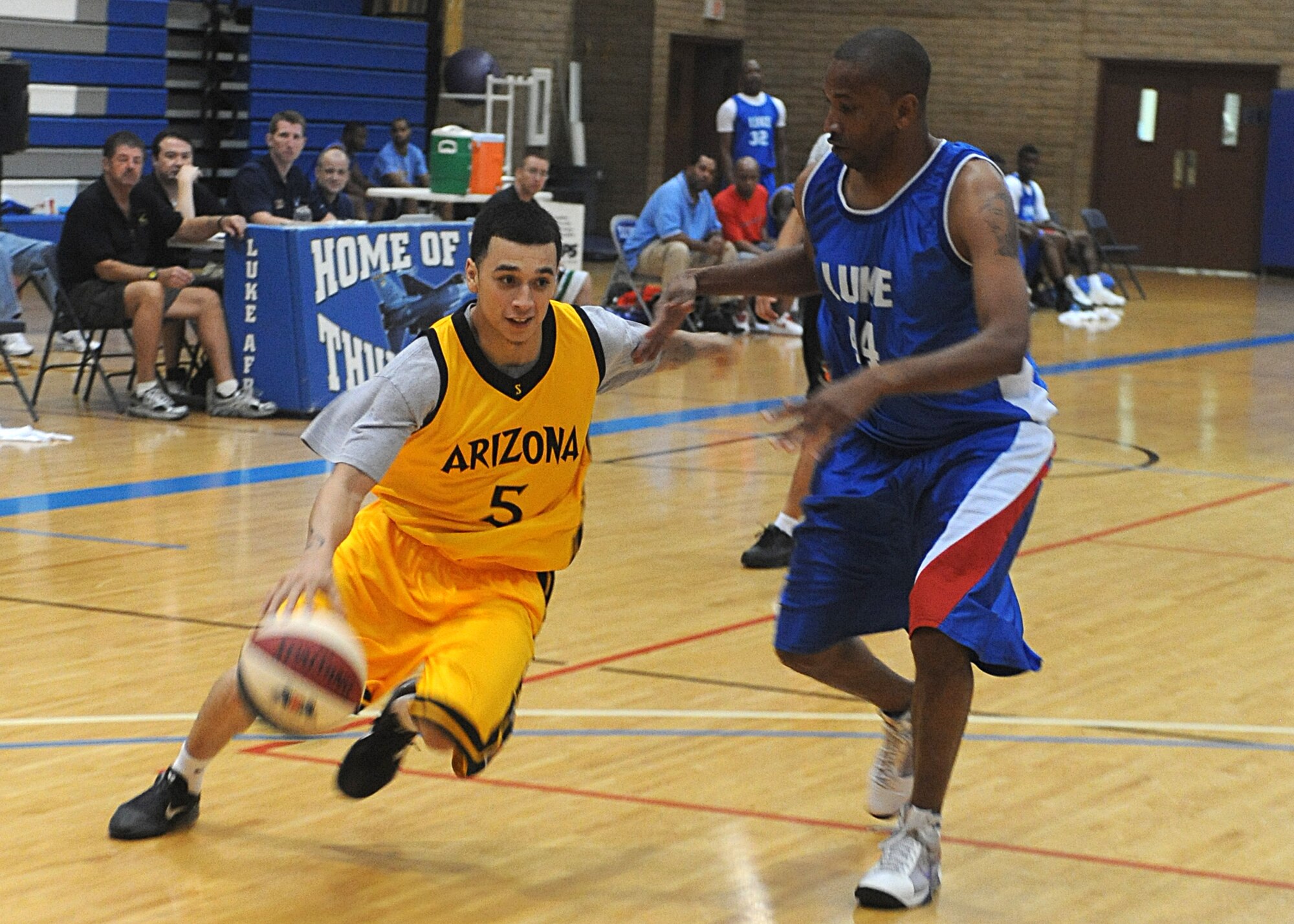 Johnny Pena, Arizona Scorpions point guard, attempts to pass the defender in a game against the Luke Air Force Base team Oct. 06, 2012 at the Bryan Fitness Center on Luke AFB, Ariz., The play resulted in a foul and two points awarded to the Scorpions. (U.S. Air Force photo by Airman 1st Class Devante Williams)