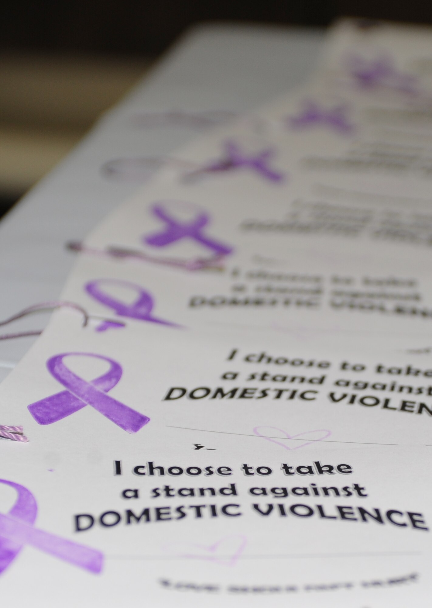 Support cards line a table at the Domestic Violence Awareness 5K run/walk at Cannon Air Force Base, N.M., Oct. 10 2012. October is Domestic Violence Awareness Month and is dedicated toward helping to break the cycle of domestic violence in America. (U.S. Air Force photo/Airman 1st Class Ericka Engblom)