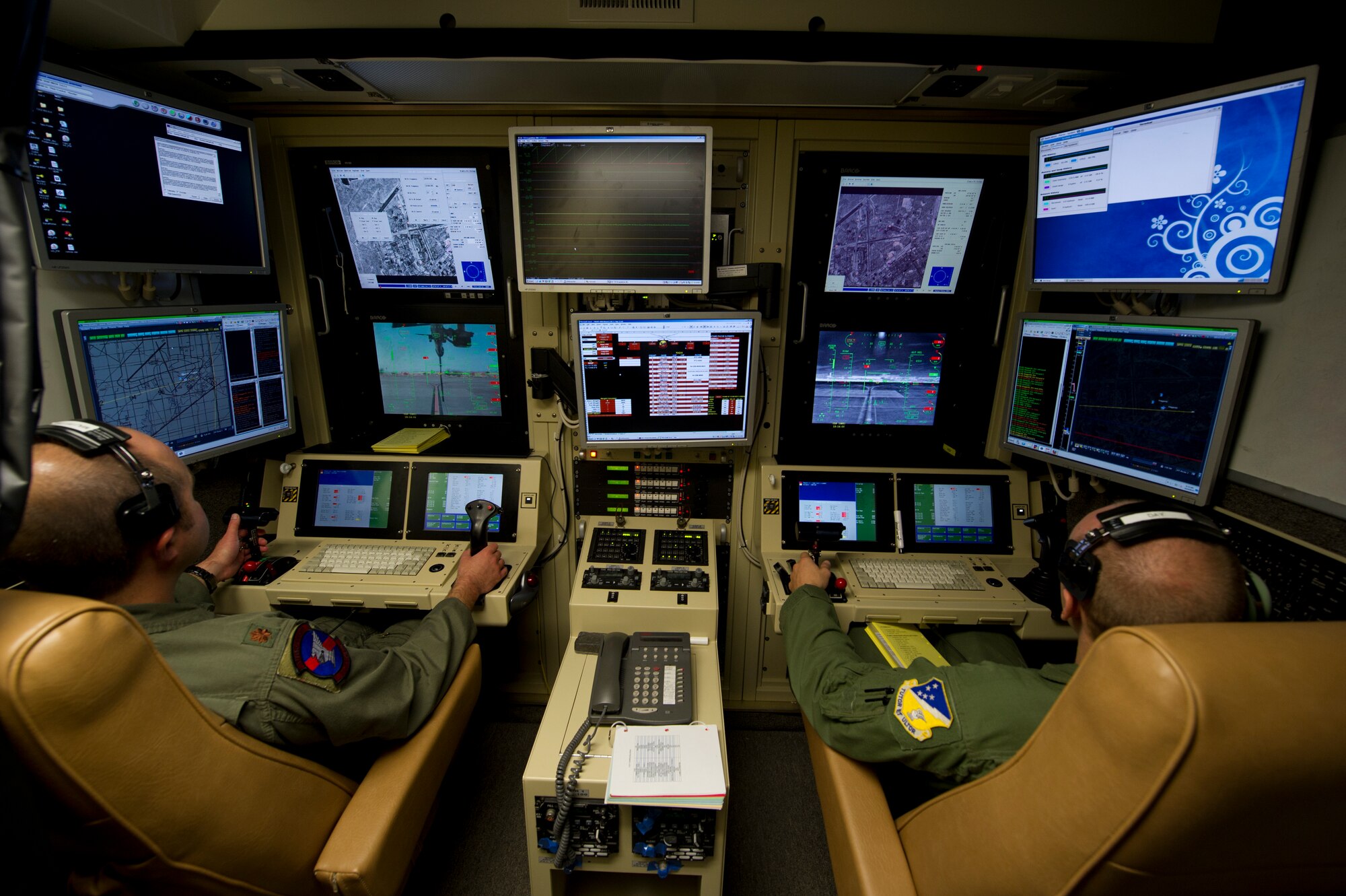 Major Dusty, 9th Attack Squadron MQ-9 Reaper pilot, and TSgt Trevis, 49th Operations Group MQ-9 sensor operator (last names omitted due to operational security concerns) fly an MQ-9 Reaper from a ground control station on Holloman Air Force Base, N.M., Oct. 3. The Reaper is a multi-functional aircraft that supports both reconnaissance and combat roles. Holloman trains all Air Force MQ-1 Predator and MQ-9 Reaper pilots. (U.S. Air Force photo by Airman 1st Class Michael Shoemaker/Released)