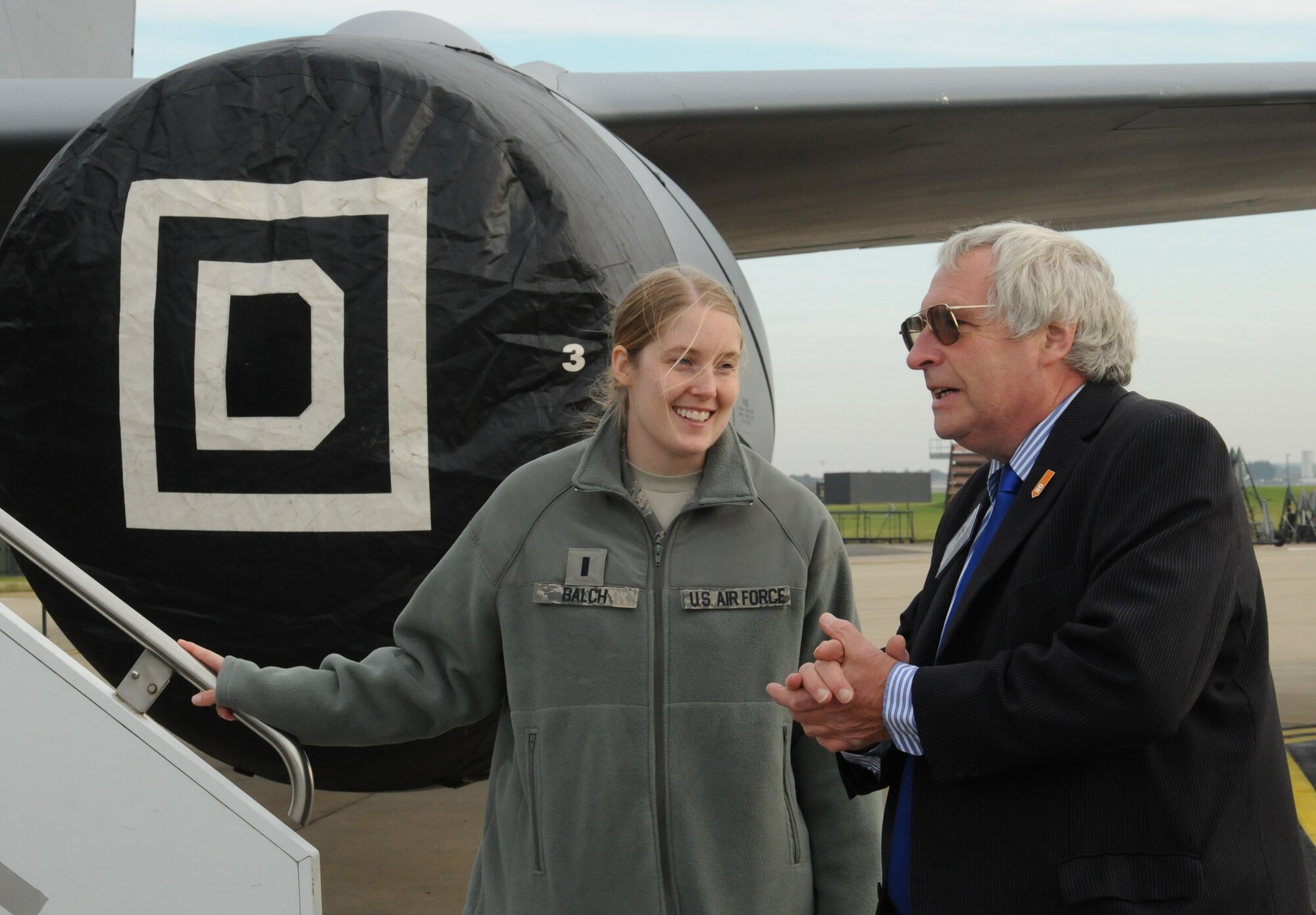 Robert Scott speaks with 1st Lt. Laura Balch, 100th Air Refueling Wing Public Affairs deputy chief, while viewing a KC-135 Stratotanker aircraft Oct. 11, 2012, at RAF Mildenhall, England. Scott attended a base tour with members of the Suffolk Chamber of Commerce to bolster relations between the local community and the base. (U.S. Air Force photo by Tech. Sgt. Neal X. Joiner/Released) 