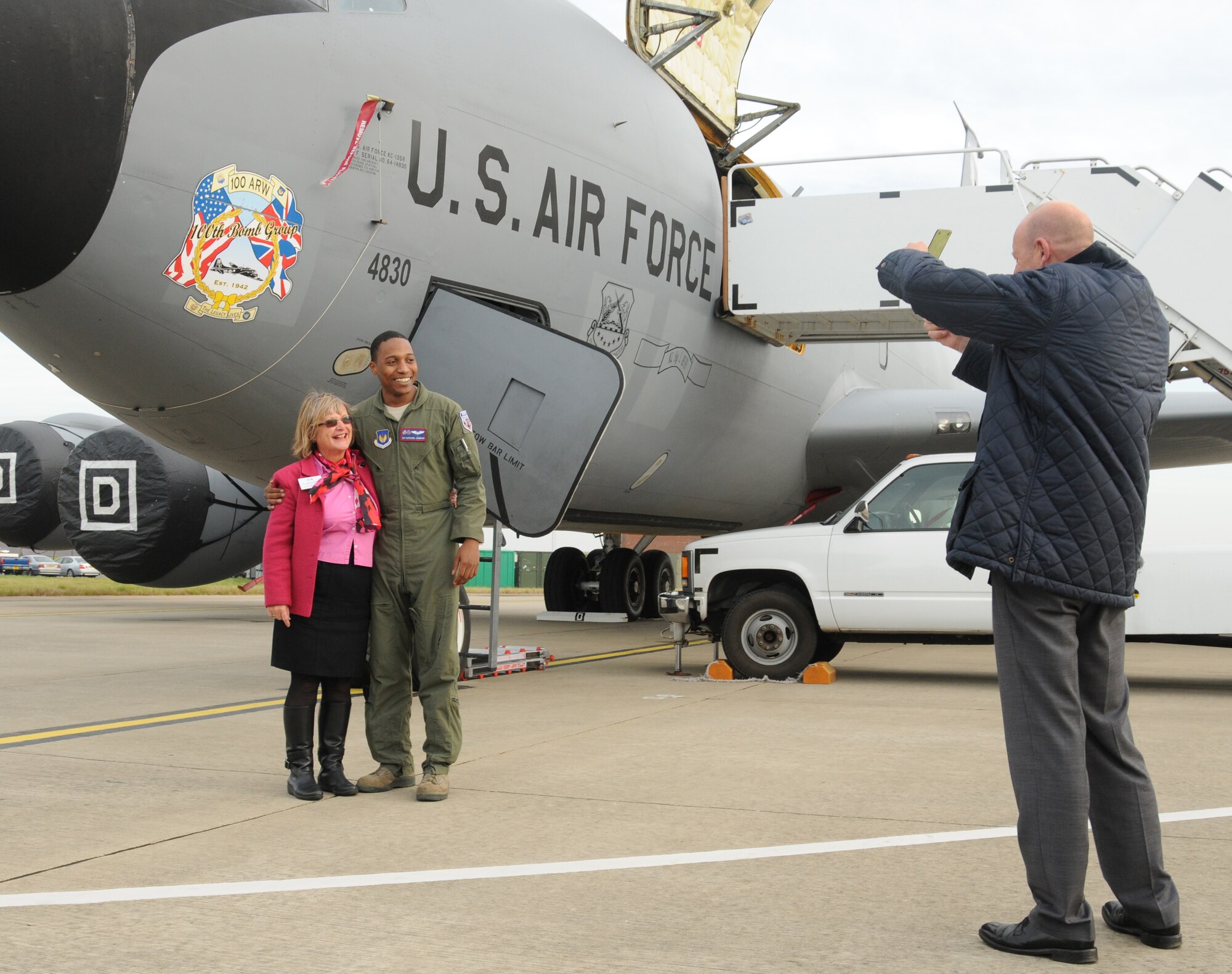 Rowena Hughes, Suffolk Chamber of Commerce, and Airman 1st Class Nathaniel Hammond, 351st Air Refueling Squadron boom operator, pose for a photo in front of a KC-135 Stratotanker aircraft Oct. 11, 2012, at RAF Mildenhall, England. Hughes was at the base for a tour with members of the chamber to bolster relations between the local community and the base. (U.S. Air Force photo by Tech. Sgt. Neal X. Joiner/Released) 