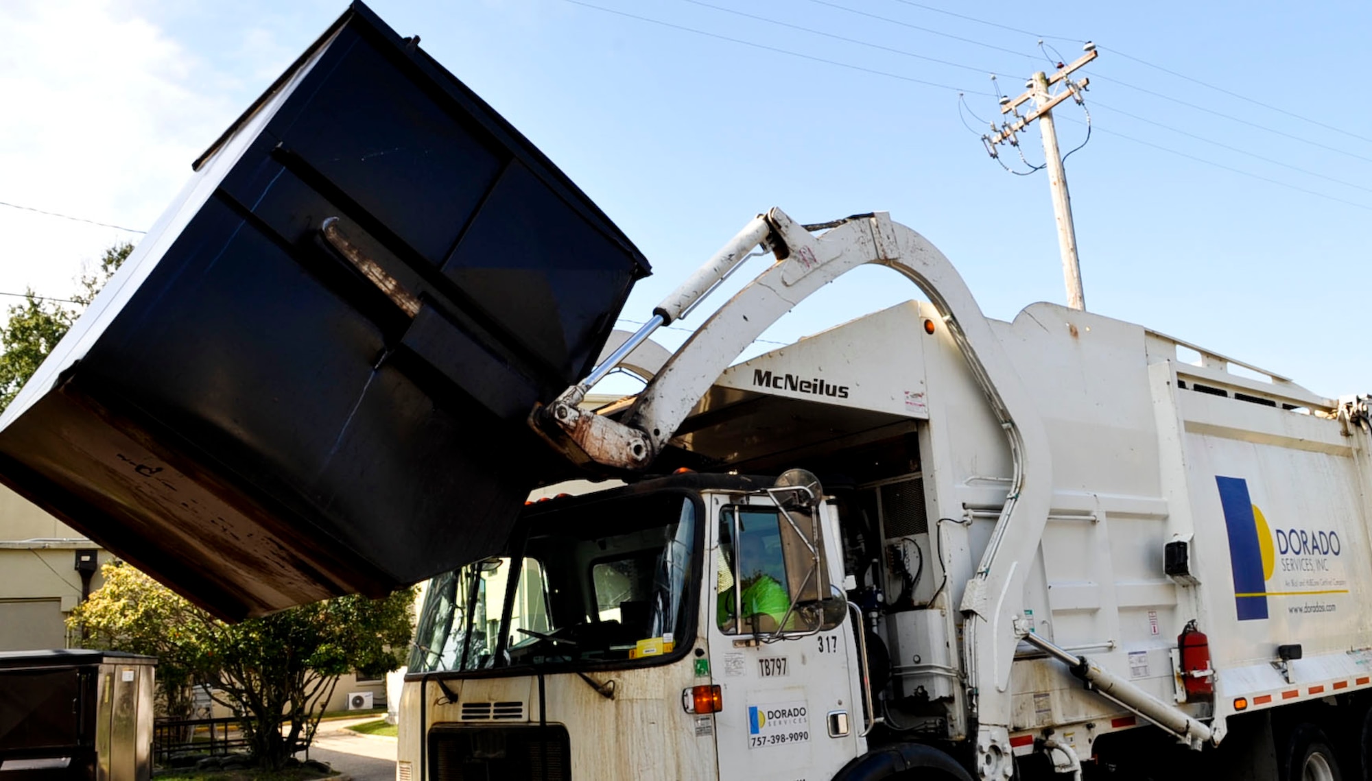 Contractors collect solid waste from a facility on Fort Eustis Oct. 5, 2012. A new solid-waste contract streamlines the installation's collection program, which will save the Army more than $826,000 over the life of the contract, while making collection easier for post customers. (U.S. Air Force photo by Staff Sgt. Wesley Farnsworth/Released)