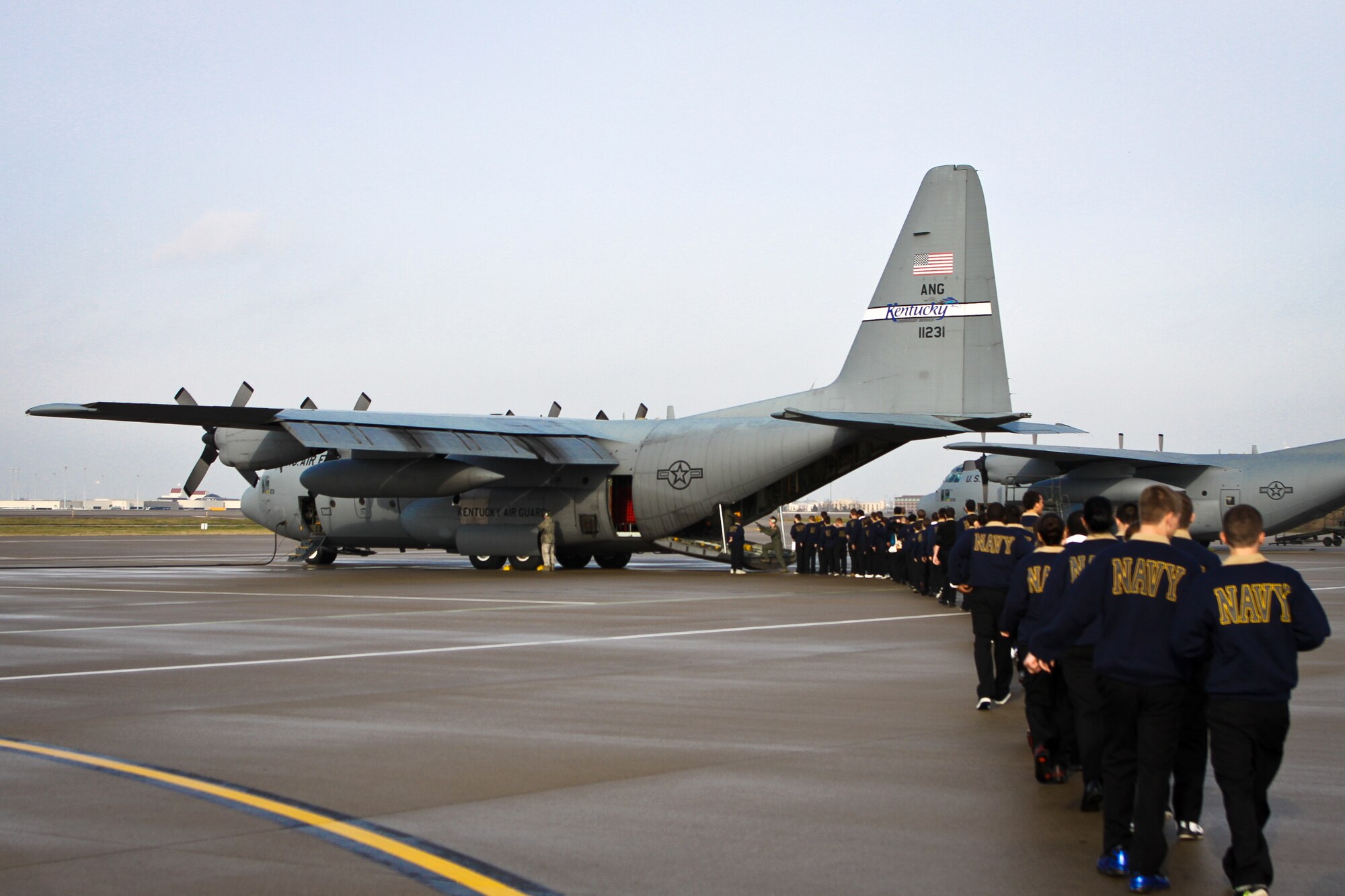 Cadets from the Navy Junior ROTC program at Valley High School in Louisville, Ky., board a Kentucky Air National Guard C-130 on the flight line of the Kentucky Air Guard Base in Louisville, Ky., Dec. 14, 2011. The students flew to Wright-Patterson Air Force Base, Ohio, where they toured the U.S. Air Force Museum. (Courtesy Photo)