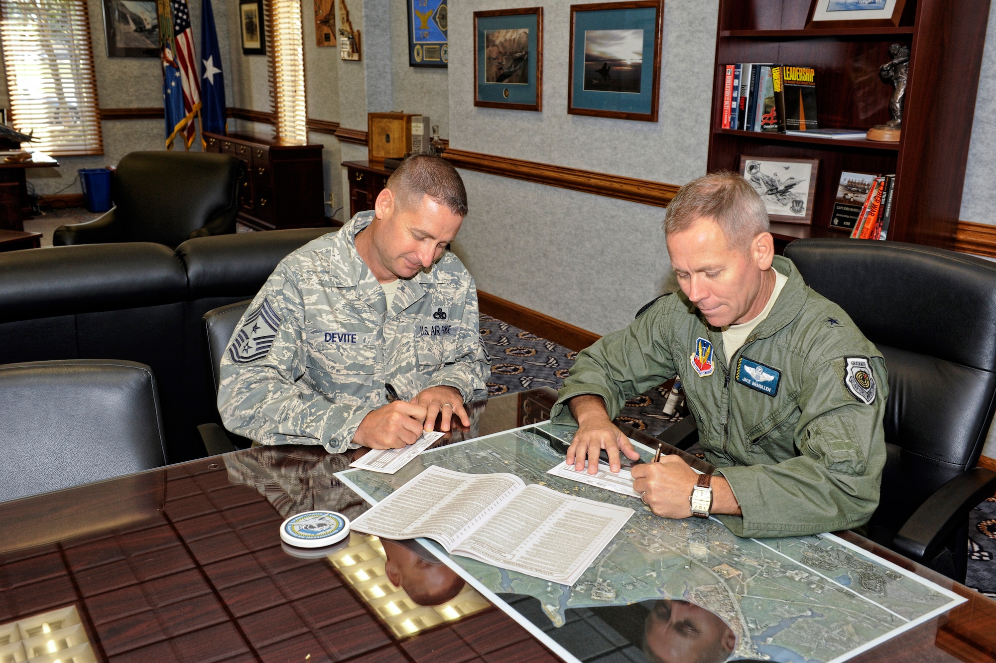 Brigadier Gen. John McMullen, 325th Fighter Wing commander, and Chief Master Sgt. Raymond DeVite, 325th FW command chief, are the first to donate to the Combined Federal Campaign. The CFC provides Federal employees the opportunity to support local, national, and international philanthropic organizations. For more information or to donate, contact your unit CFC point of contact team member. (U.S. Air Force photo by Chris Cokeing)