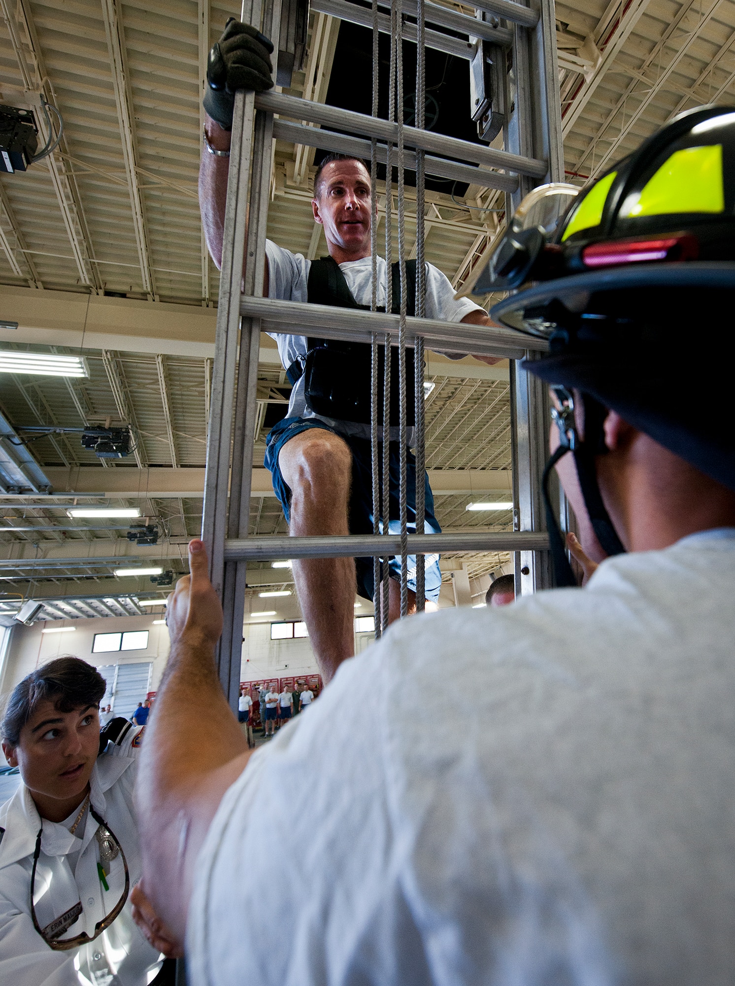 Chief Master Sgt. Karl Day, of the 96 Medical Operations Squadron, makes one of three climbs up a ladder as part of the Chiefs versus Eagles Fire Prevention Week Challenge Oct. 9 at Eglin Air Force Base, Fla.  Colonels and chief master sergeants raced through a series of firefighting physical activities to see who could finish first.  The challenges included hose dragging, ladder climbing, victim carry and more.  Four colonels and seven chiefs competed and their scores were averaged to determine the winner.  The Eagles won by 12 seconds, but the chiefs quickly pointed out that had they chosen to only have four competitors, they’d have taken the victory by a second.  (U.S. Air Force photo/Samuel King Jr.)