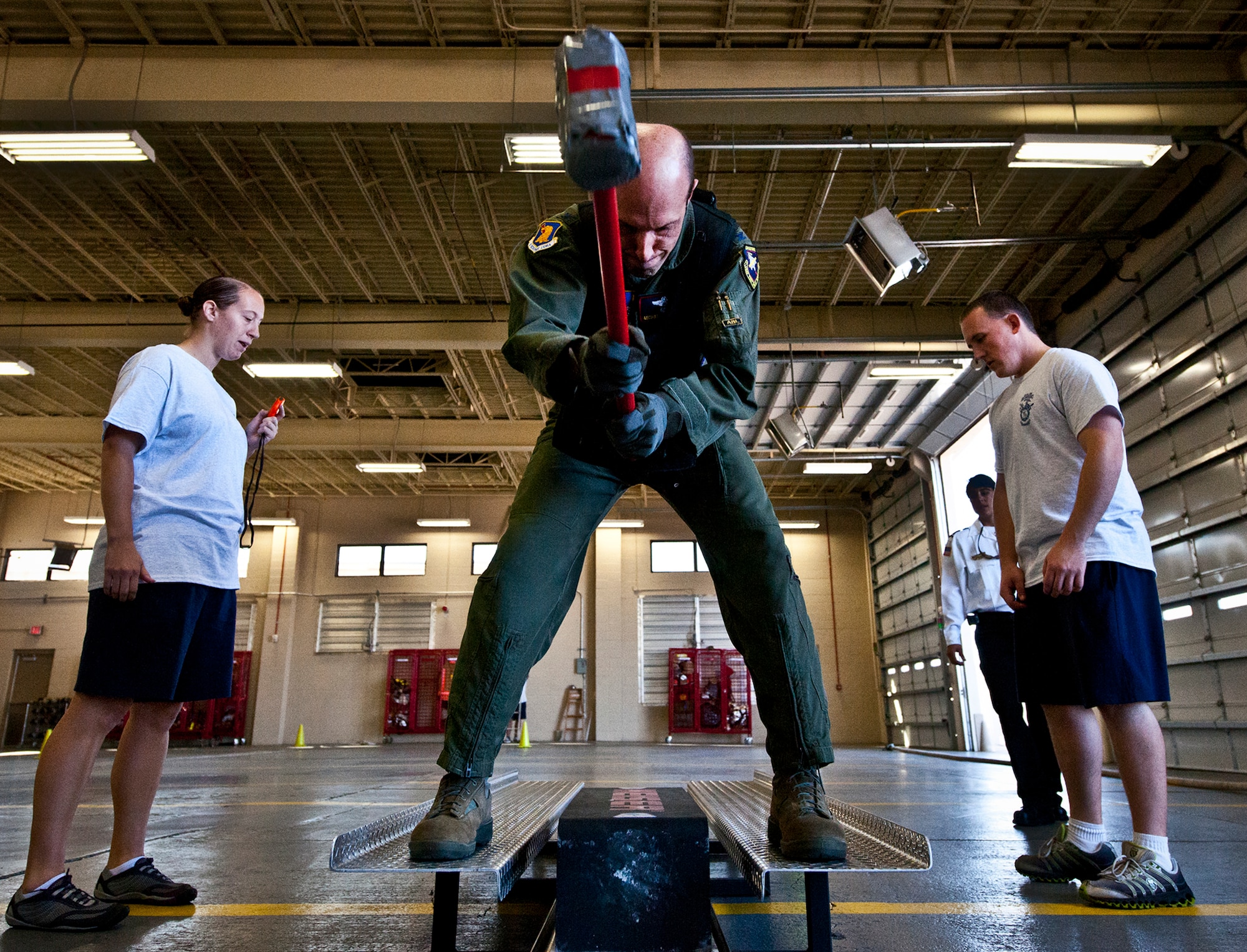 Col. Michael Contratto, the 96th Test Wing operations vice commander, brings a sledgehammer down through the sled as part of the Chiefs versus Eagles Fire Prevention Week Challenge Oct. 9 at Eglin Air Force Base, Fla.  Colonels and chief master sergeants raced through a series of firefighting physical activities to see who could finish first.  The challenges included hose dragging, ladder climbing, victim carry and more.  Four colonels and seven chiefs competed and their scores were averaged to determine the winner.  The Eagles won by 12 seconds, but the chiefs quickly pointed out that had they chosen to only have four competitors, they’d have taken the victory by a second.  (U.S. Air Force photo/Samuel King Jr.)