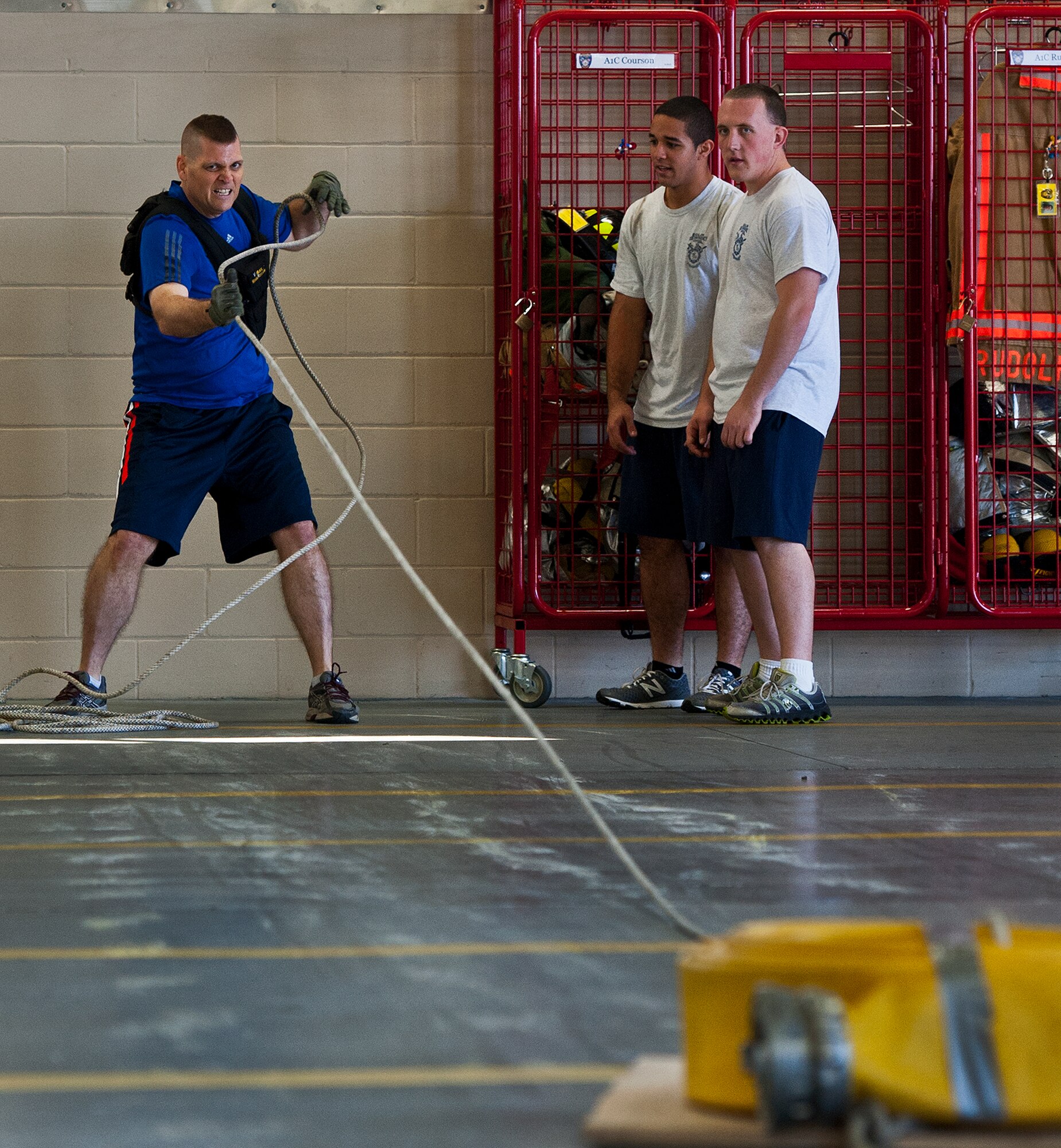 Col. Anthony Higdon, the 96th Civil Engineer Group commander, pulls a water hose sled across the length of the firehouse as part of the Chiefs versus Eagles Fire Prevention Week Challenge Oct. 9 at Eglin Air Force Base, Fla.  Colonels and chief master sergeants raced through a series of firefighting physical activities to see who could finish first.  The challenges included hose dragging, ladder climbing, victim carry and more.  Four colonels and seven chiefs competed and their scores were averaged to determine the winner.  The Eagles won by 12 seconds, but the chiefs quickly pointed out that had they chosen to only have four competitors, they’d have taken the victory by a second.  (U.S. Air Force photo/Samuel King Jr.)