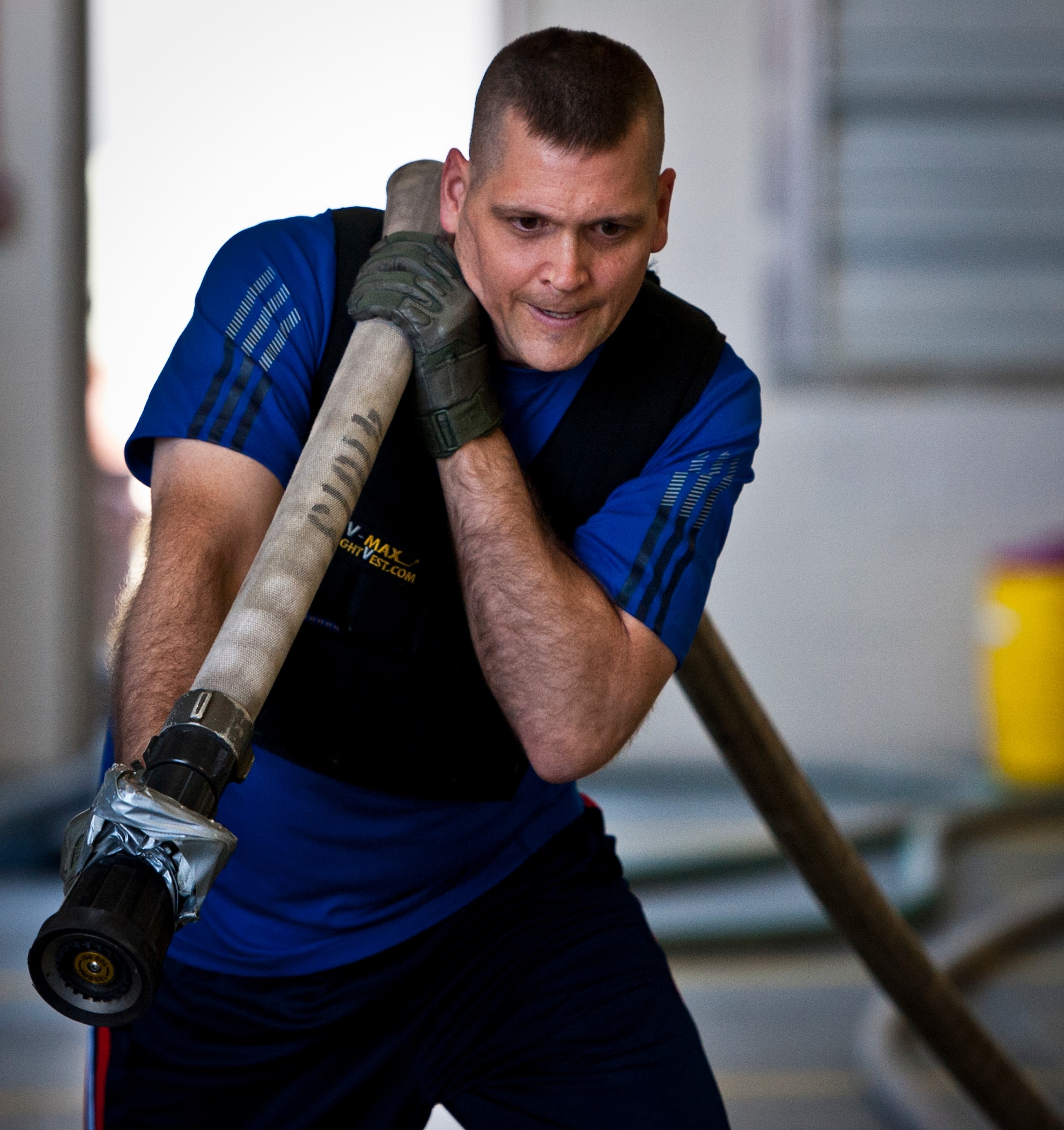 Col. Anthony Higdon, the 96th Civil Engineer Group commander, pulls a full water hose across a finish line as part of the Chiefs versus Eagles Fire Prevention Week Challenge Oct. 9 at Eglin Air Force Base, Fla.  Colonels and chief master sergeants raced through a series of firefighting physical activities to see who could finish first.  The challenges included hose dragging, ladder climbing, victim carry and more.  Four colonels and seven chiefs competed and their scores were averaged to determine the winner.  The Eagles won by 12 seconds, but the chiefs quickly pointed out that had they chosen to only have four competitors, they’d have taken the victory by a second.  (U.S. Air Force photo/Samuel King Jr.)