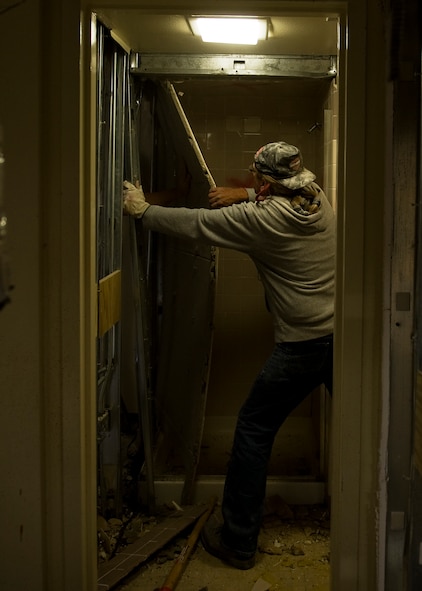 Martinez Lionel, contractor, tears down a wall in the Parish Hall dormitory Oct. 10, 2012, during a renovation project at Dyess Air Force Base, Texas. The $8 million project recently began for Parish and Andrews Hall, which upgrades 128 rooms, making them 33 percent larger, with washers and dryers. The renovation is scheduled to be complete near the end of 2013. (U.S. Air Force photo by Airman 1st Class Damon Kasberg/ Released)