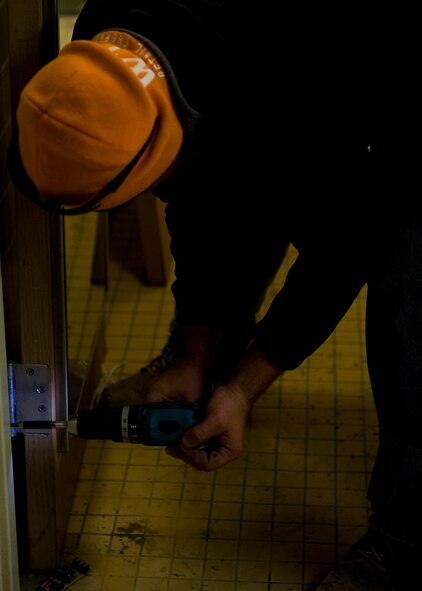 Danny Bamber, contractor, removes a door from the Andrews Hall dormitory Oct. 10, 2012, during a renovation project at Dyess Air Force Base, Texas. The $8 million project recently began for Parish and Andrews Hall, which upgrades 128 rooms, making them 33 percent larger, with washers and dryers. The renovation is scheduled to be complete near the end of 2013. (U.S. Air Force photo by Airman 1st Class Damon Kasberg/ Released)