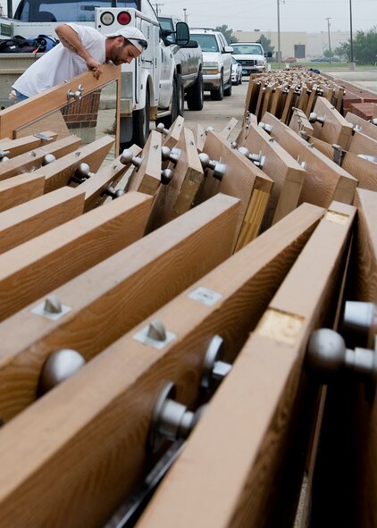 Terrell Carter, contractor, stacks old doors together from the Parish Hall dormitory Oct. 10, 2012, during a renovation project at Dyess Air Force Base, Texas. The $8 million project recently began for Parish and Andrews Hall, which upgrades 128 rooms, making them 33 percent larger, with washers and dryers. The renovation is scheduled to be complete near the end of 2013. (U.S. Air Force photo by Airman 1st Class Damon Kasberg/ Released)