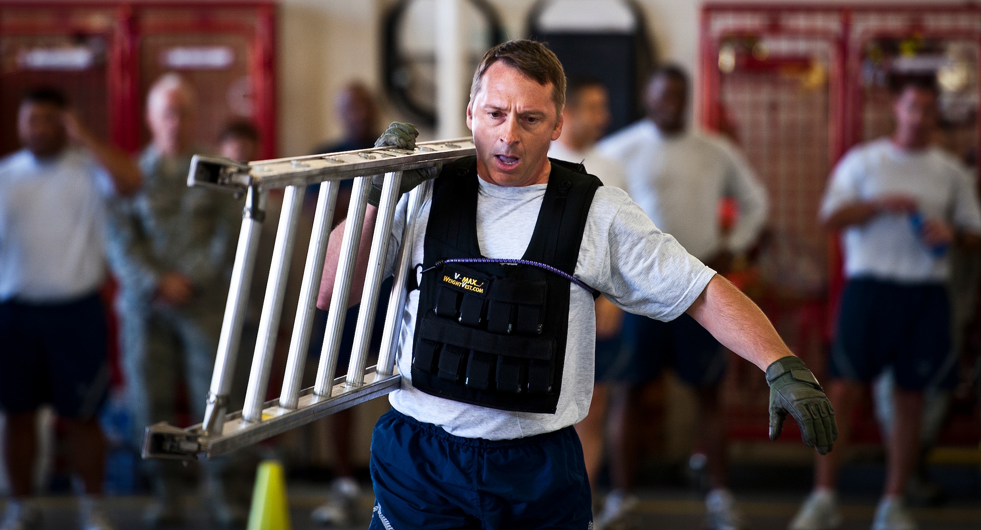 Col. David Hicks, the 53rd Wing commander, carries a ladder as part of the Chiefs versus Eagles Fire Prevention Week Challenge Oct. 9 at Eglin Air Force Base, Fla.  Colonels and chief master sergeants raced through a series of firefighting physical activities to see who could finish first.  The challenges included hose dragging, ladder climbing, victim carry and more.  Four colonels and seven chiefs competed and their scores were averaged to determine the winner.  The Eagles won by 12 seconds, but the chiefs quickly pointed out that had they chosen to only have four competitors, they’d have taken the victory by a second.  (U.S. Air Force photo/Samuel King Jr.)