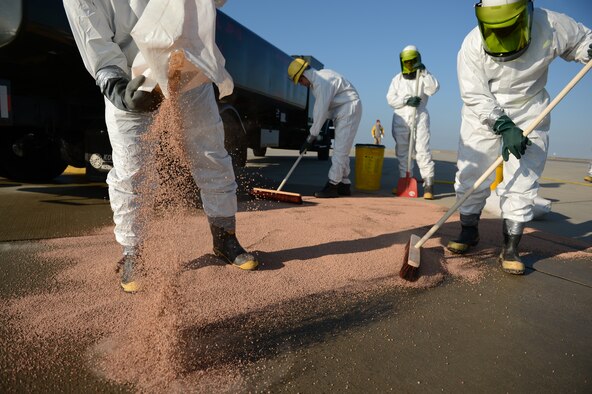 SPANGDAHLEM AIR BASE, Germany – Airmen from the 52nd Civil Engineer Squadron water and fuel systems maintenance shop spread petroleum absorbent rocks across the scene of a simulated fuel spill on the flightline Oct. 10, 2012. The scenario is a mandated annual exercise that tests first responder capabilities for fuel spills on the flightline. (U.S. Air Force photo by Staff Sgt. Nathanael Callon/Released)