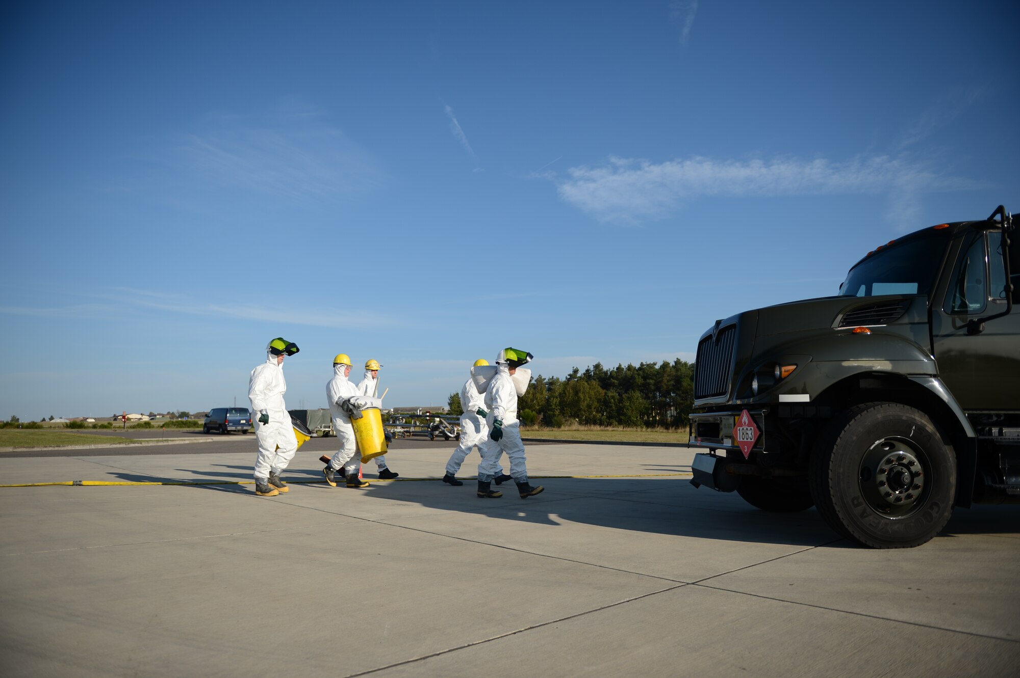 SPANGDAHLEM AIR BASE, Germany – Airmen from the 52nd Civil Engineer Squadron water and fuel systems maintenance shop walk to the scene of a simulated fuel spill on the flightline Oct. 10, 2012. The team cleans up major fuel spills like this after first responders deem the site safe. (U.S. Air Force photo by Staff Sgt. Nathanael Callon/Released)