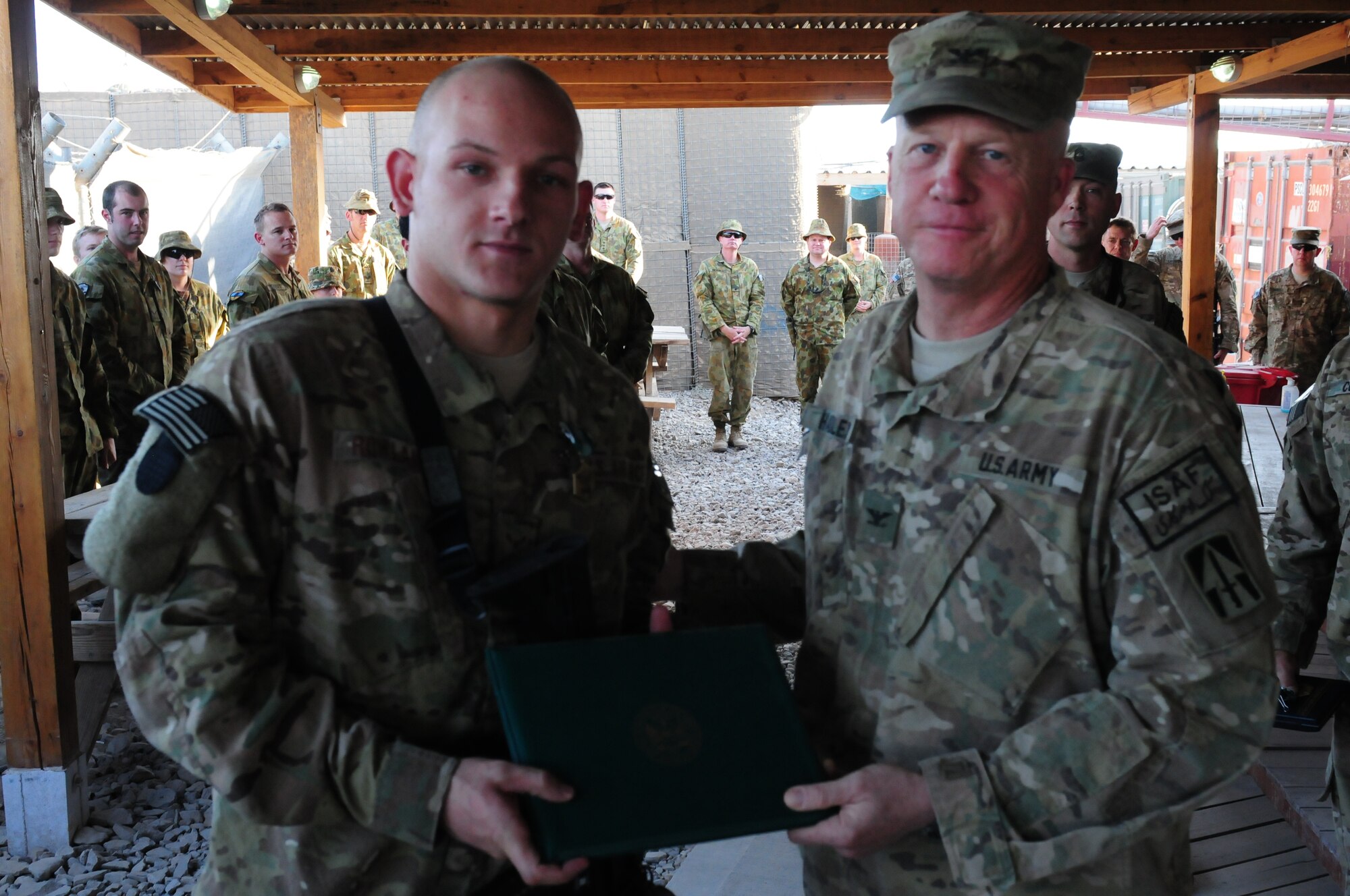 Col. Hadley, commander of the 76th IBCT, presents Airman 1st Class, 113th ASOS, the Army Commendation Medal.