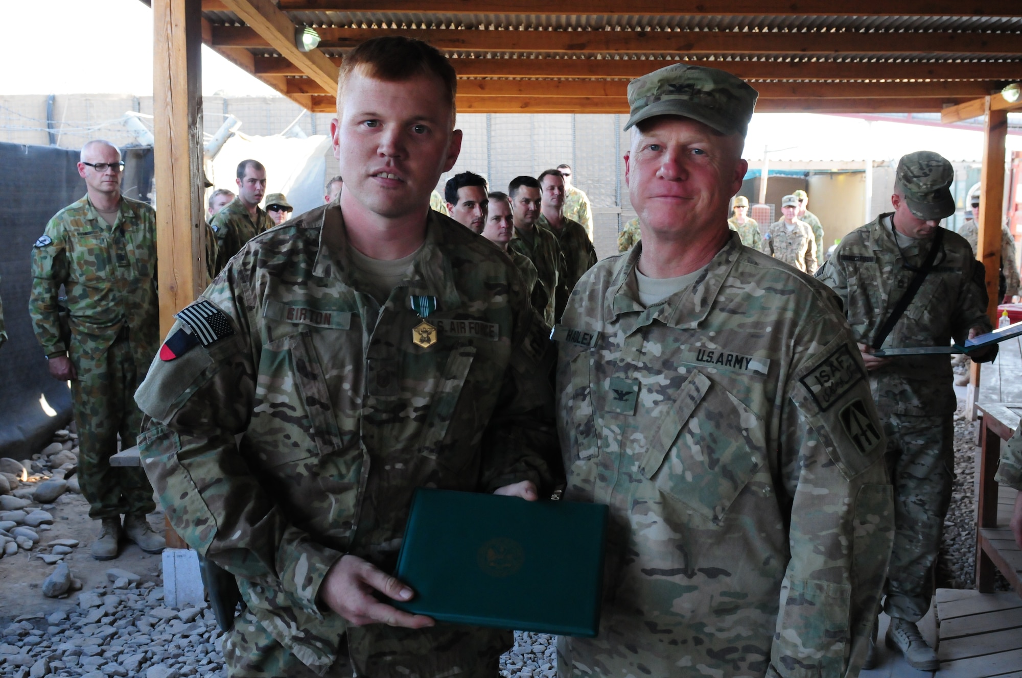 Col. Hadley, commander of the 76th IBCT, presents Master Sgt. Girton, 113th ASOS, the Army Commendation Medal.