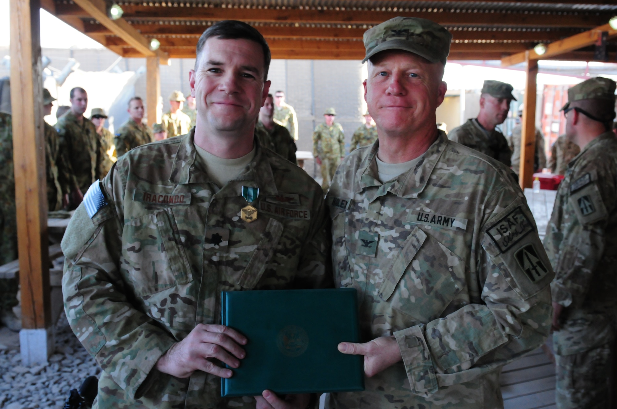 Col. Hadley, commander of the 76th IBCT, presents Lt. Col. Iracondo, 113th ASOS, the Army Commendation Medal.