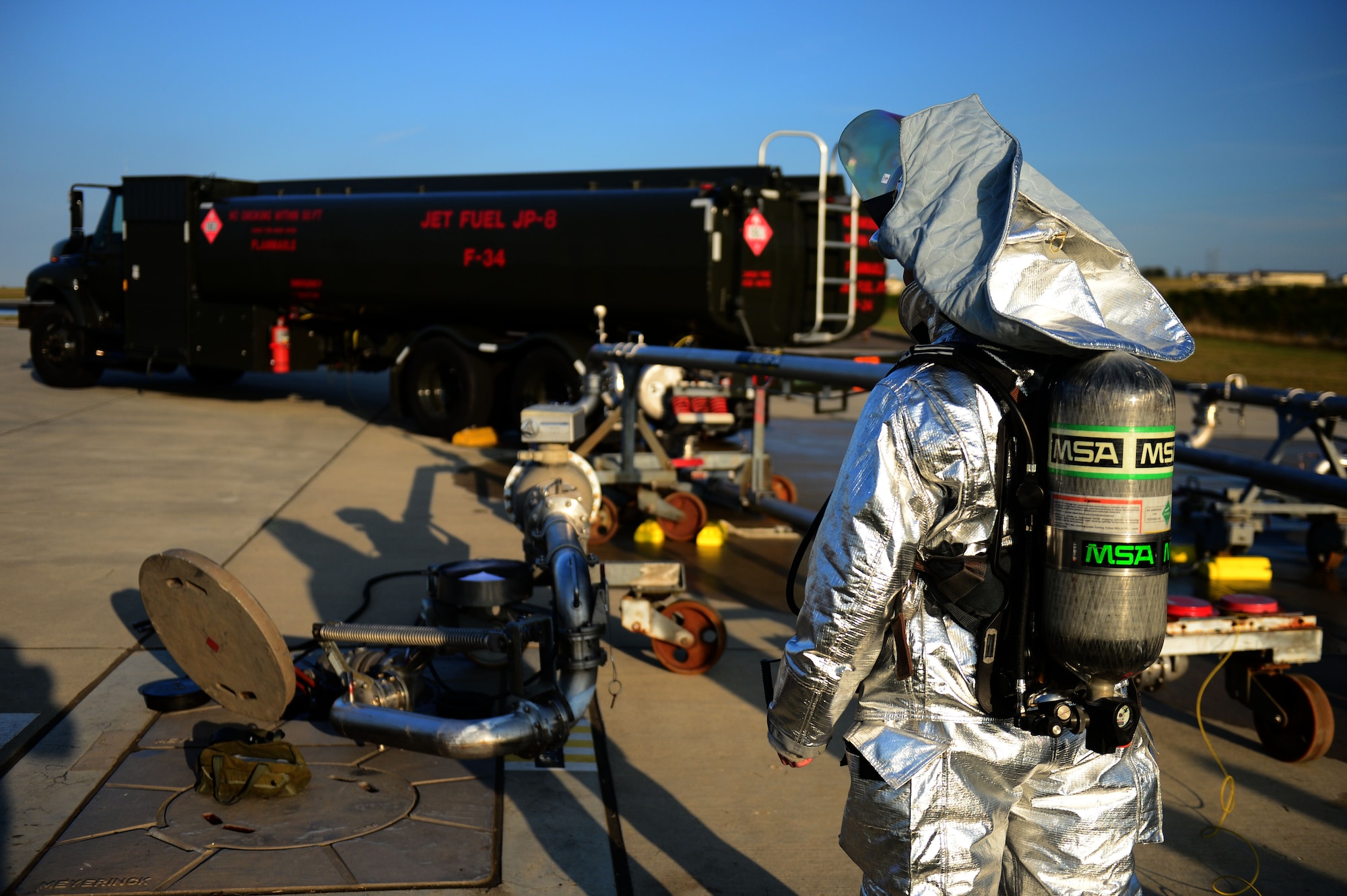 SPANGDAHLEM AIR BASE, Germany – U.S. Air Force Airman 1st Class Alexander Hernandez, 52nd Civil Engineer Squadron firefighter from Riverside, Calif., surveys the scene during a fuel spill exercise on the flightline Oct. 10, 2012.  This Defense Logistics Agency-required exercise is performed once a year to keep emergency responders prepared for potential real-world incidents. (U.S. Air Force photo by Airman 1st Class Gustavo Castillo/Released)