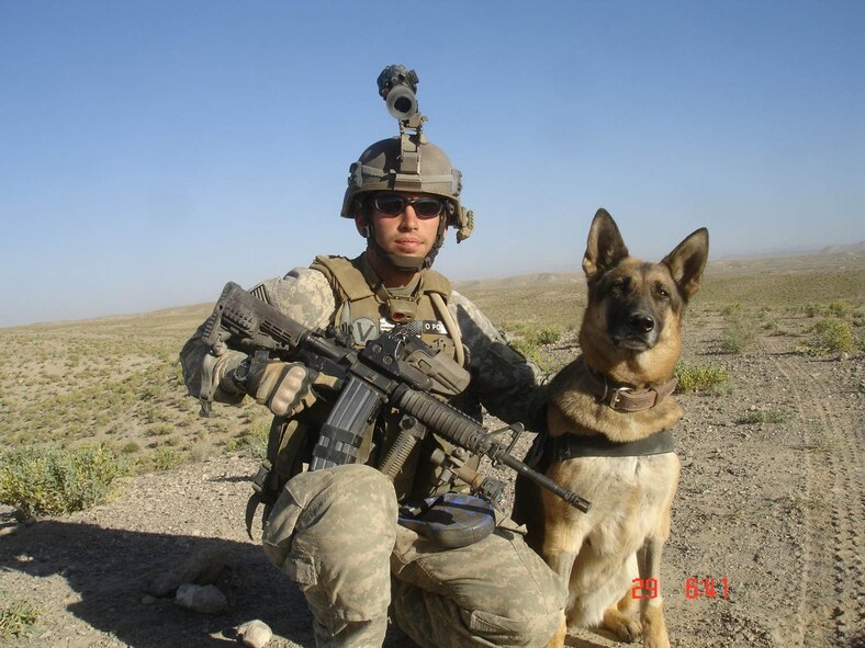 AFGHANISTAN -- During a tour of duty in 2009, Tech. Sgt. Steven Kaun, 5th
Security Forces Squadron military working dog handler, and his trusted K-9
partner Gitta, served proudly together in support of the overseas mission.
Kaun recounted a story of how Gitta, who has since passed away, helped in
detecting a roadside bomb which saved the lives of fellow service members.
(Courtesy photo)