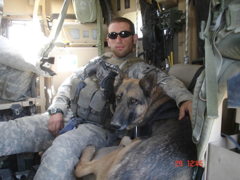AFGHANISTAN -- During a tour of duty in 2009, Tech. Sgt. Steven Kaun, 5th
Security Forces Squadron military working dog handler, and his trusted K-9
partner Gitta, served proudly together in support of the overseas mission.
Kaun recounted a story of how Gitta, who has since passed away, helped in
detecting a roadside bomb which saved the lives of fellow service members.
(Courtesy photo)