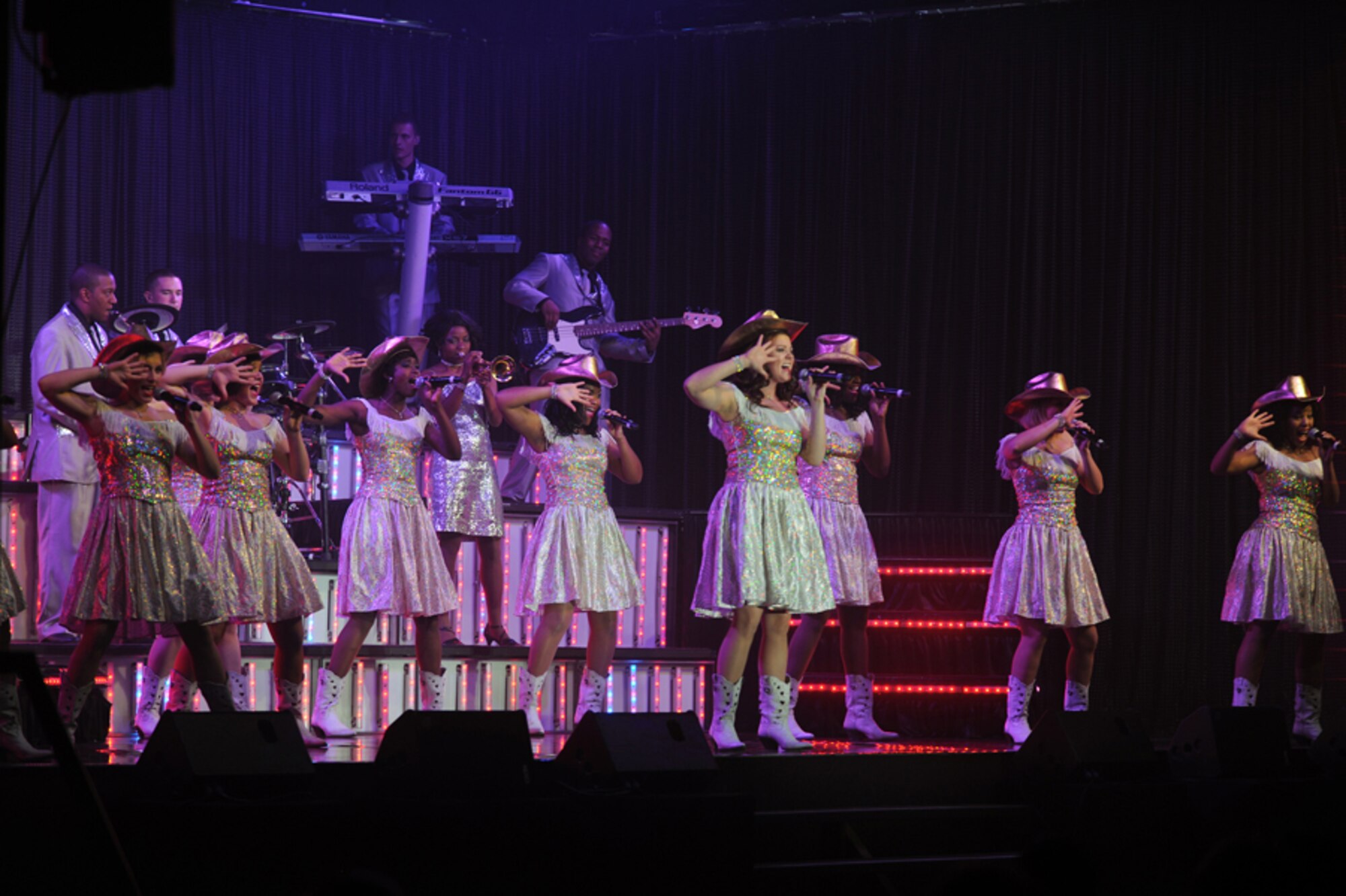 RAF FAIRFORD, United Kingdom – Members of the Tops In Blue 2012 World Tour perform in Hangar 1205 at RAF Fairford Oct. 5. The group sang and danced for an audience of nearly 900 members of the local community. (U.S. Air Force photo by Staff Sgt. Brian Stives)