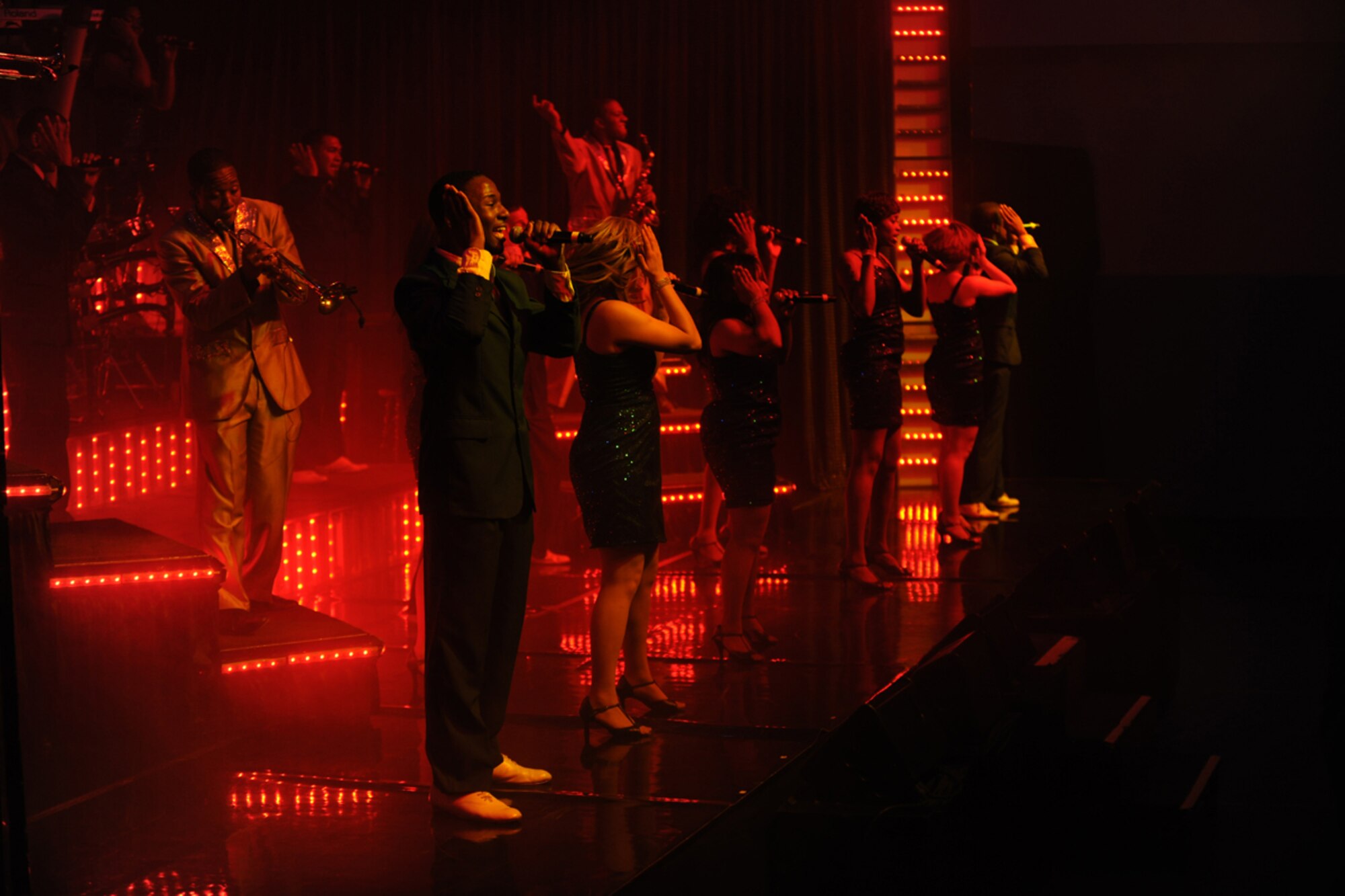 RAF CROUGHTON, United Kingdom – Members of the Tops In Blue 2012 World Tour perform at the RAF Croughton Fitness Center Oct. 4. The group sang and danced for an audience of nearly 260 members of the 422nd Air Base Group and local community. (U.S. Air Force photo by Master Sgt. John Barton)