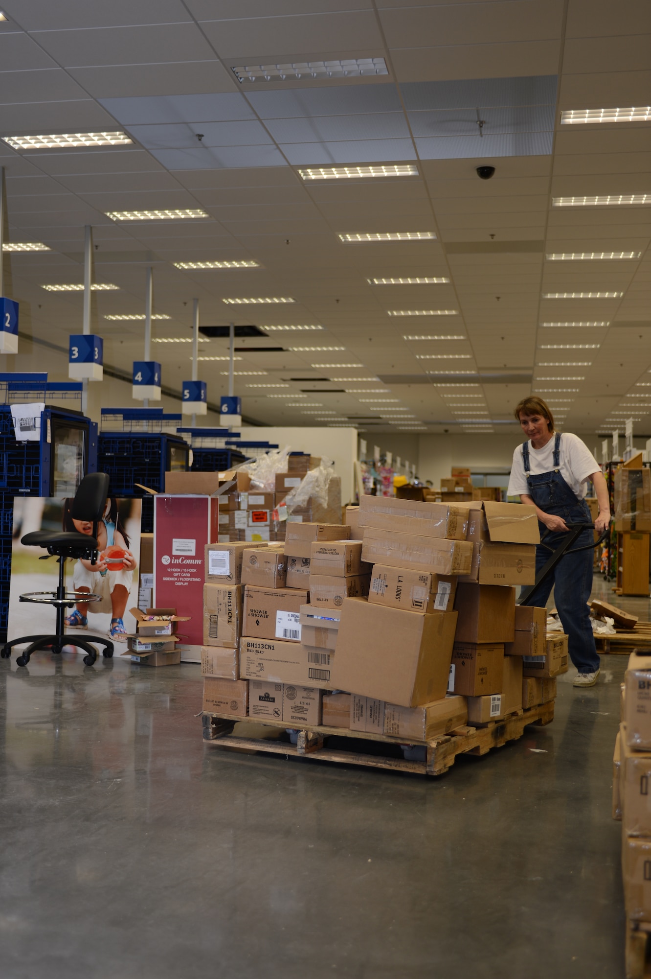 SPANGDAHLEM AIR BASE, Germany – Petra Gervais, Exchange loader from Herforst, stocks shelves at the new Spangdahlem Exchange. The new Exchange main store hours of operation are 10 a.m. – 8 p.m.  Monday through Saturday, and 10 a.m. – 6 p.m. Sunday and holidays. The current Spangdahlem and Bitburg Exchanges close Oct. 31.  (U.S. Air Force photo by Senior Airman Natasha Stannard/Released)