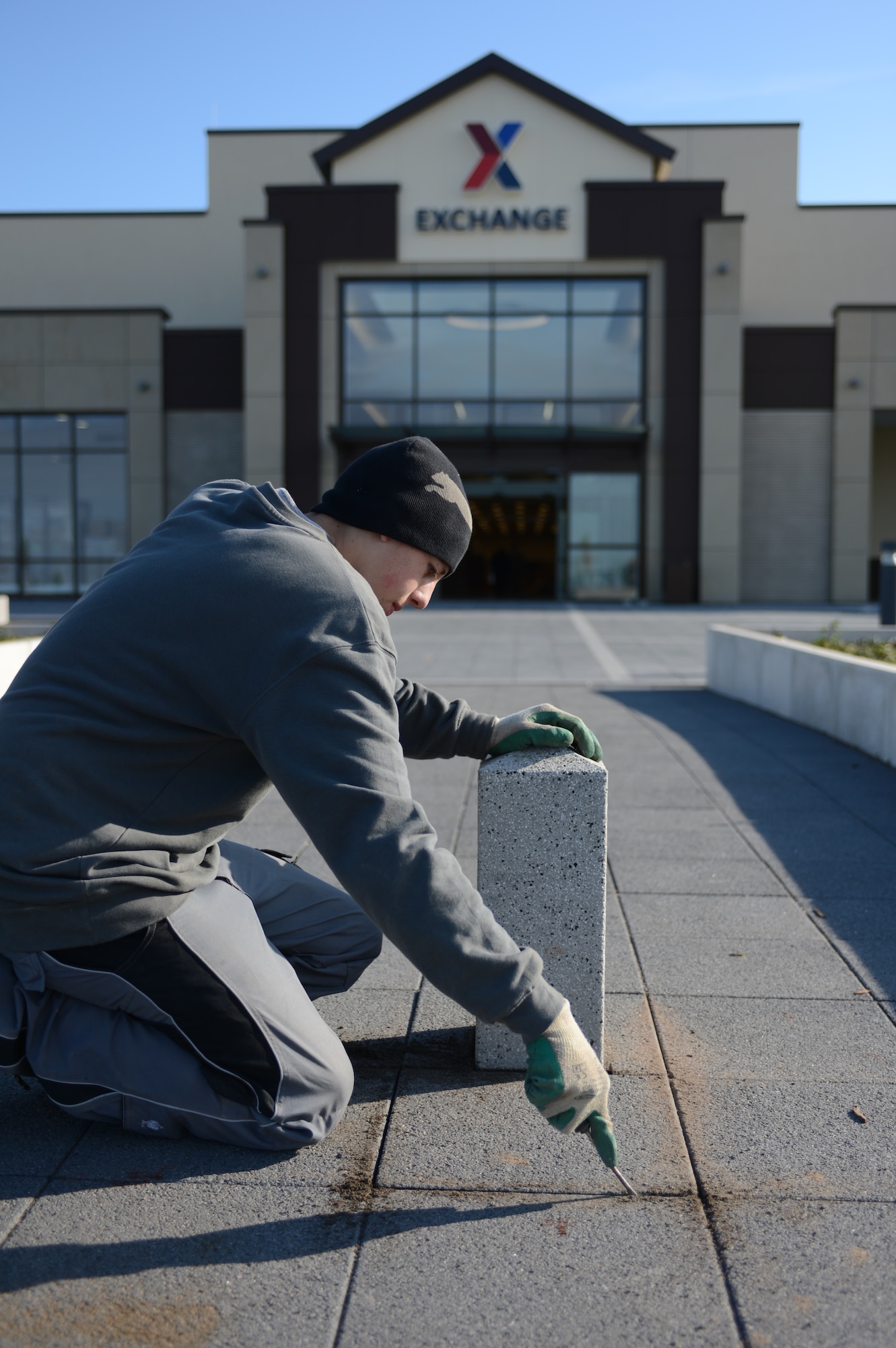 SPANGDAHLEM AIR BASE, Germany – Zachery Lake, Fogenbau contractor from Alamogordo, N.M., removes pillars from the front entrance of the new Spangdahlem Exchange Oct. 11, 2012. The Exchange opens Nov. 2 and includes a new food court and concession stands. (U.S. Air Force photo by Senior Airman Natasha Stannard/Released)