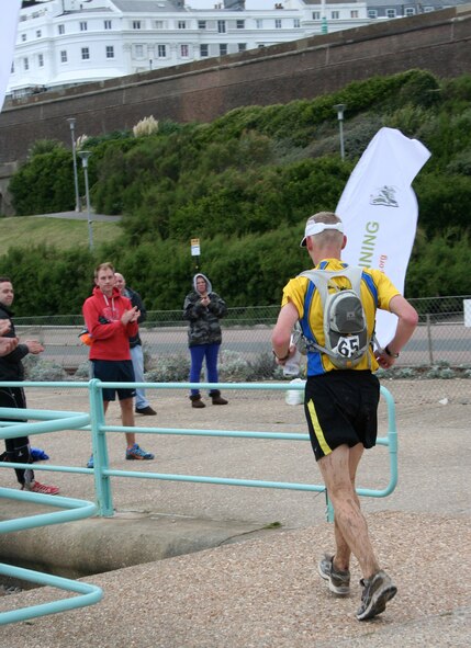 Lt. Col. Chris Bennett, 100th Operations Support Group commander, RAF Mildenhall, England, heads towards the finish line in Brighton at the end of the London-to-Brighton ultra marathon Sept. 30, 2012. After running 27 marathons, Bennett gave himself a new challenge and signed up for the ultra marathon, which was 61.2 miles. He also ran the Air Force Marathon at Wright-Patterson Air Force Base, Ohio, Sept. 15. (Courtesy photo/Molly Bennett)