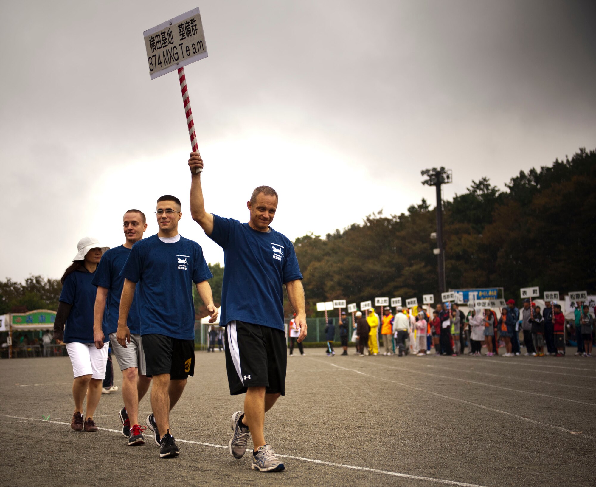 MIZUHO TOWN, Japan -- Airmen from the 374th Maintenance Group from Yokota Air Base, Japan, participate in the opening ceremony parade at the Mizuho Town Sports Day event, Oct. 7, 2012. 374th MXG Airmen and their families were invited to enjoy a day of sports events and food with the Mizuho Town community. (U.S. Air Force photo by Airman 1st Class Krystal M. Garrett)