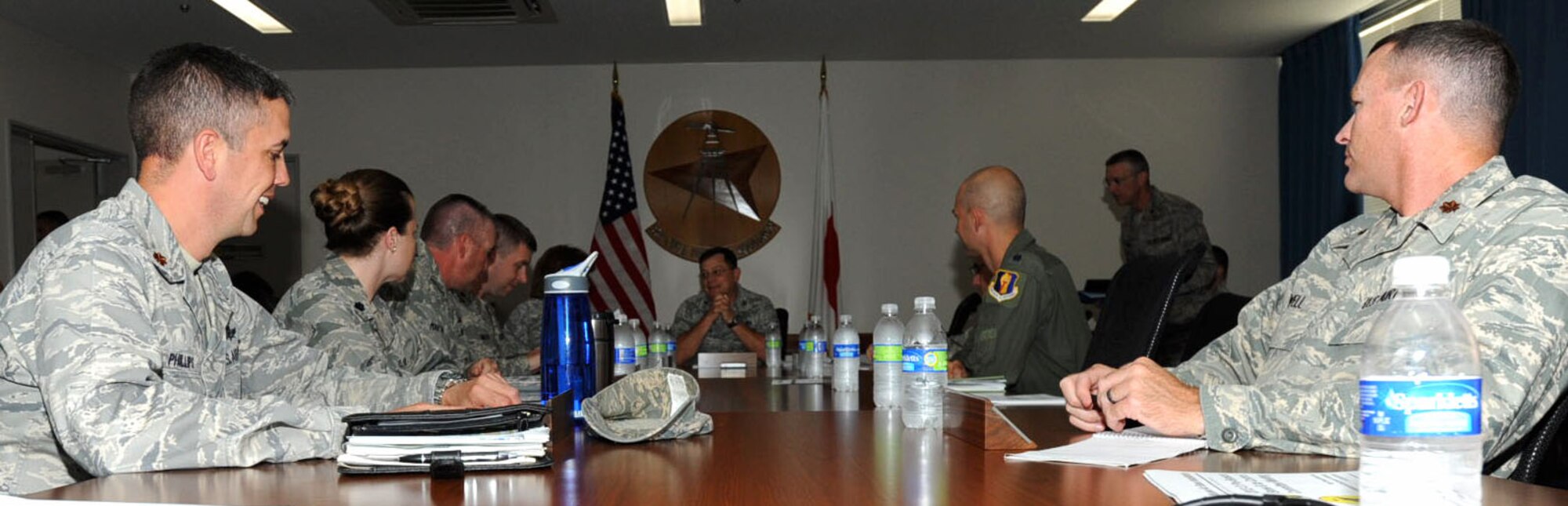 Misawa Air Base group commanders converse at the first 2012-13 pre-season snow and ice control committee meeting in the 35th Civil Engineer Squadron conference room at Misawa Air Base, Japan, Oct. 10, 2012. The committee hosts two of these meetings during the winter season to keep everyone informed of what is expected of the base snow and ice removal teams. Issues and complaints from previous years are also brought up and discussed during the meetings. (U.S. Air Force photo by Airman 1st Class Kenna Jackson)