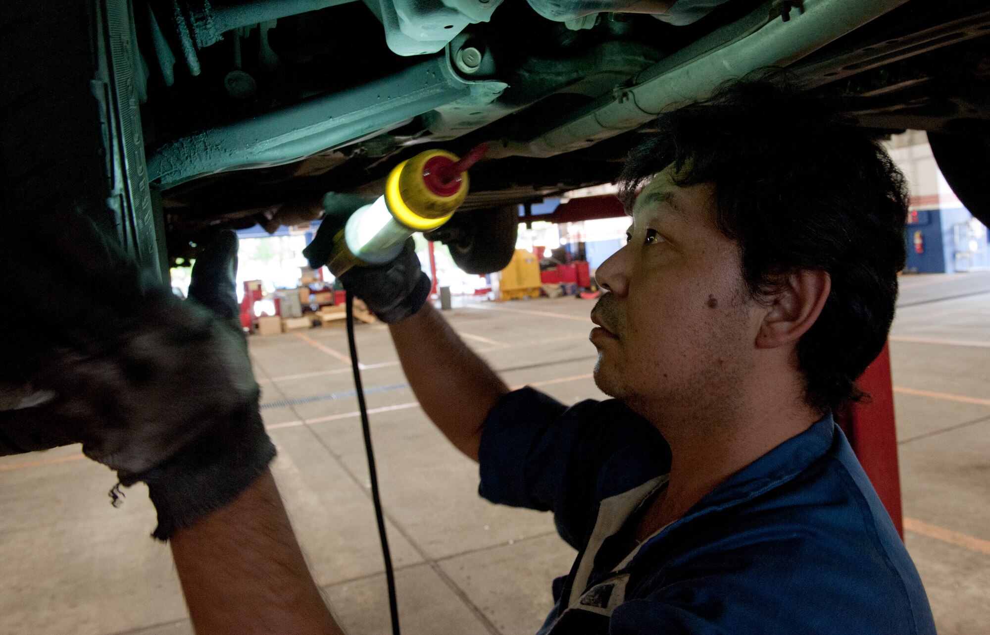YOKOTA AIR BASE, Japan -- Yokokawa Yasushi, Yokota Car Care Center mechanic, performs a safety inspection on a vehicle Oct. 4, 2012, at Yokota Air Base, Japan. The car center performs certain tasks for Yokota customers such as oil changes, tune-ups and radiator replacements. (U.S. Air Force photo by Airman 1st Class John D. Partlow)
