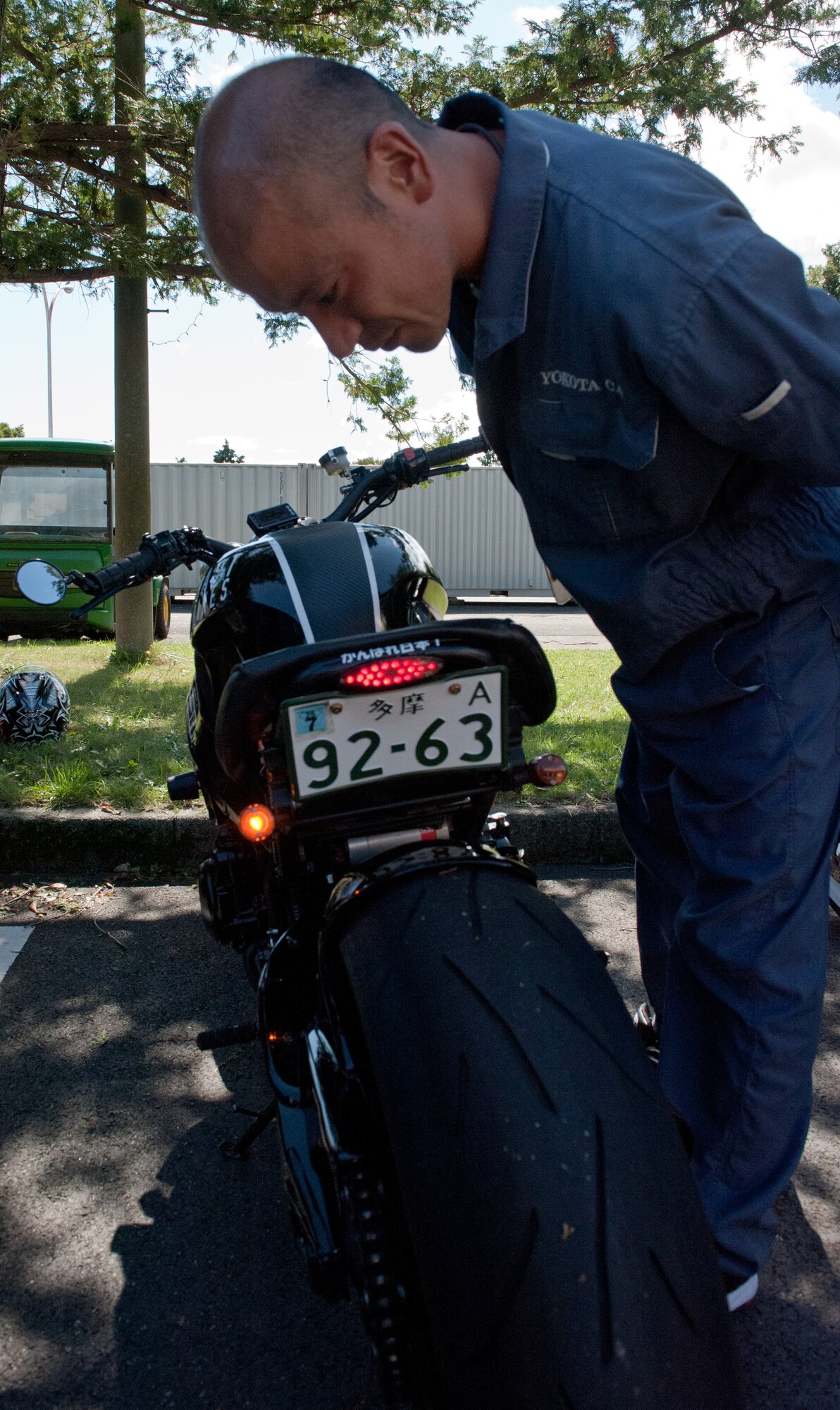 YOKOTA AIR BASE, Japan -- Mako Nomoto, Yokota Car Care Center mechanic, checks for operational turn signals on a motorcycle Oct. 4, 2012, at Yokota Air Base, Japan. The car center performs pre-Japanese car insurance inspections to help Yokota residents acquire JCI. (U.S. Air Force photo by Airman 1st Class John D. Partlow)