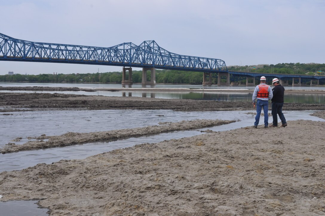 Corps employees look at the completed construction of the Peoria Upper Island project which is part of the Illinois River Basin Restoration.