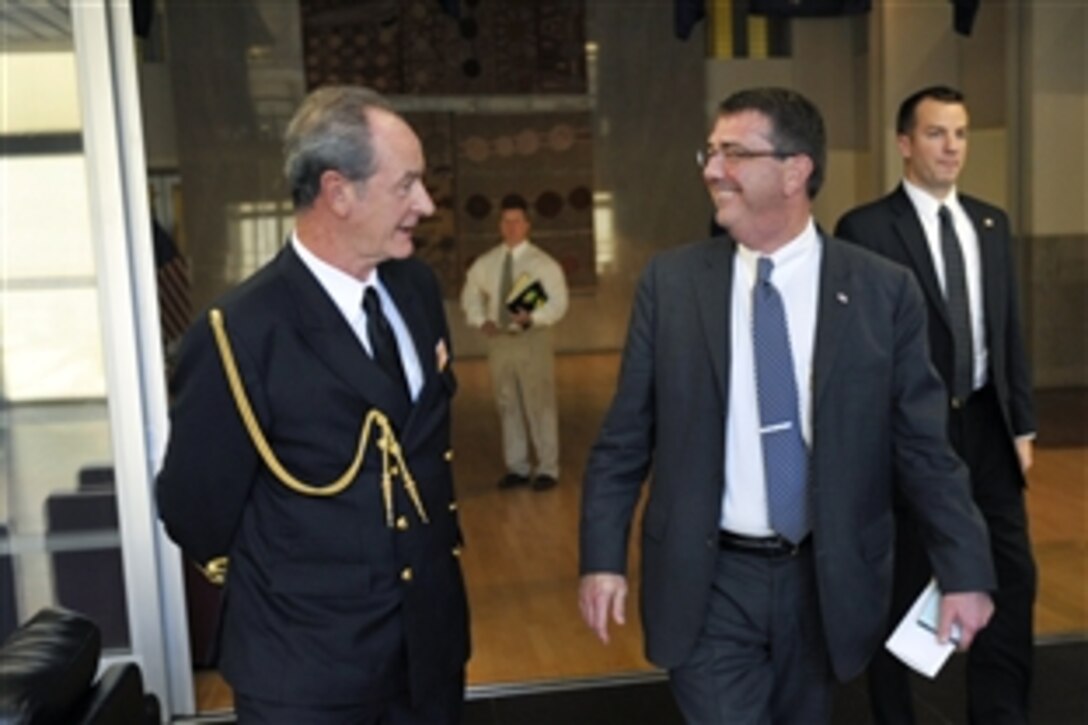 U.S. Deputy Defense Secretary Ashton B. Carter speaks with Spanish navy Rear Adm. Javier Romero after delivering remarks to the Defense Attaché Association at the Australian Embassy in Washington, D.C., Oct. 11, 2012. Romero is the association's dean.
