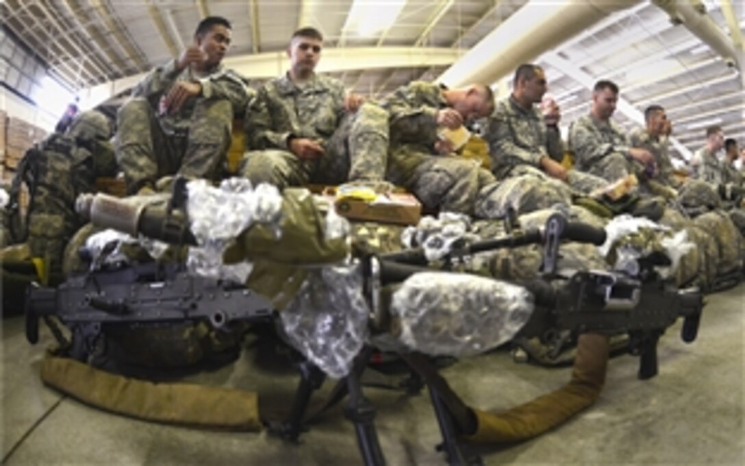 Paratroopers relax with some chow before an airborne operation on Pope Army Airfield, N.C., Oct. 8, 2012.  The paratroopers are assigned to the 82nd Airborne Division's 2nd Brigade Combat Team. About 1,300 paratroopers from the team jumped into Folk Polk, La., for a Joint Readiness Training Exercise rotation.