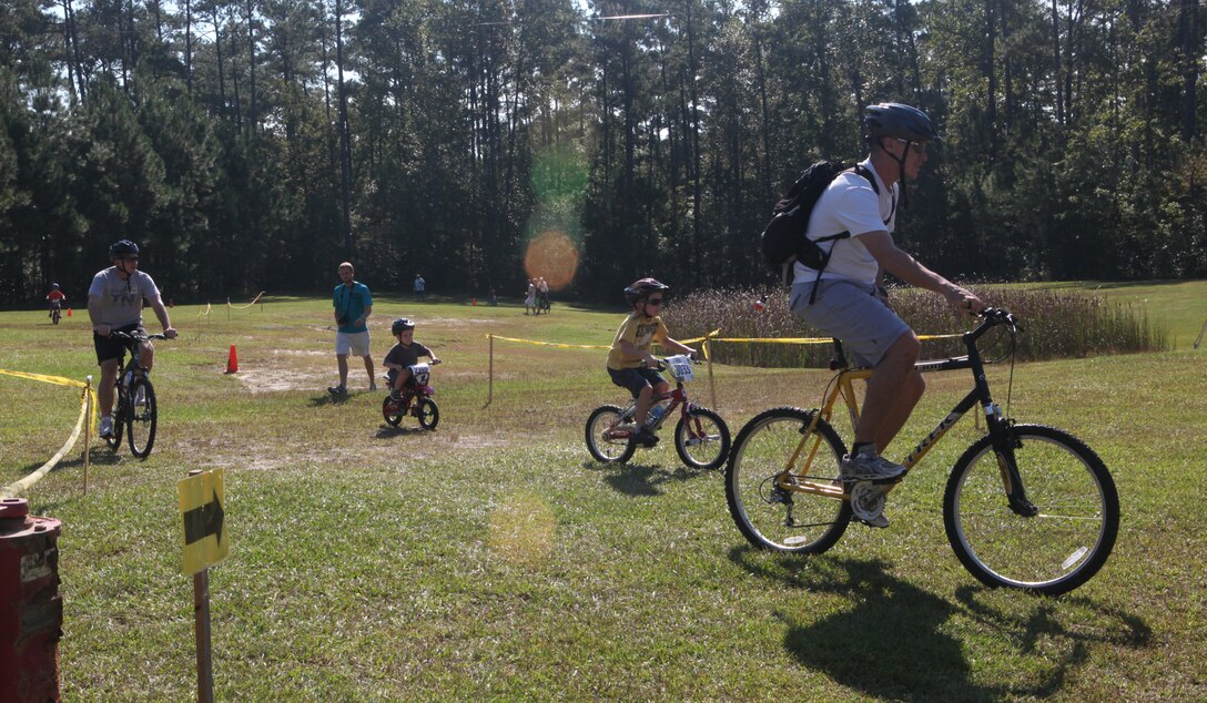 Military families bike through obstacles during Marine Corp Base Camp Lejeune’s first Take a Kid Mountain Biking Day event hosted by The National Mountain Biking Association at the Henderson recreation area Oct. 6. The event provided group rides for all ages.