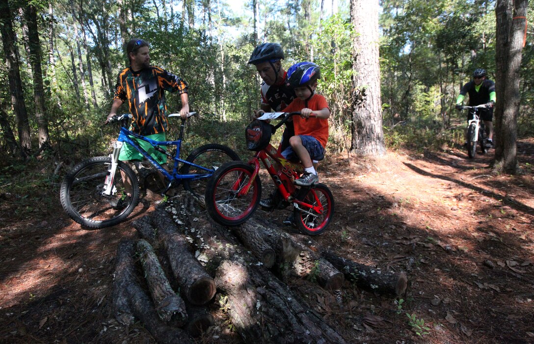 Military family members ride through biking trails during Marine Corp Base Camp Lejeune’s first Take a Kid Mountain Biking Day event hosted by The National Mountain Biking Association at the Henderson recreation area Oct. 6. The event provided group rides for all ages.