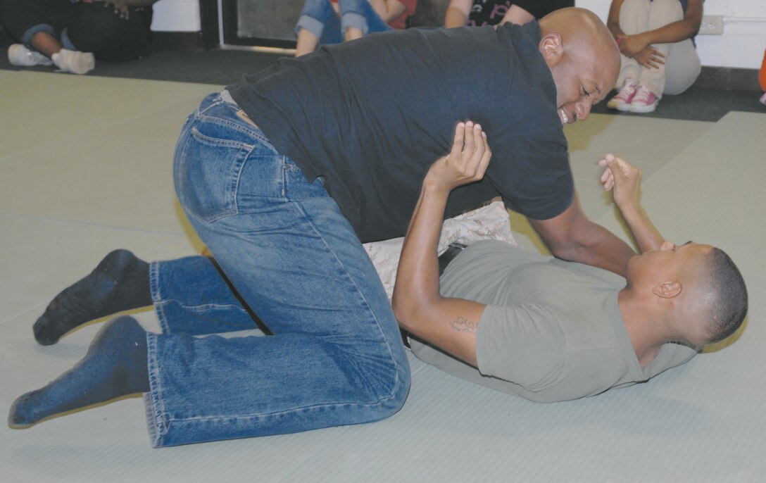 Cpl. Cameron Perry grapples with a teacher from Lee County Middle School, Leesburg, Ga., Oct. 4. More than 20 students and teachers visited Marine Corps Logistics Base Albany.
