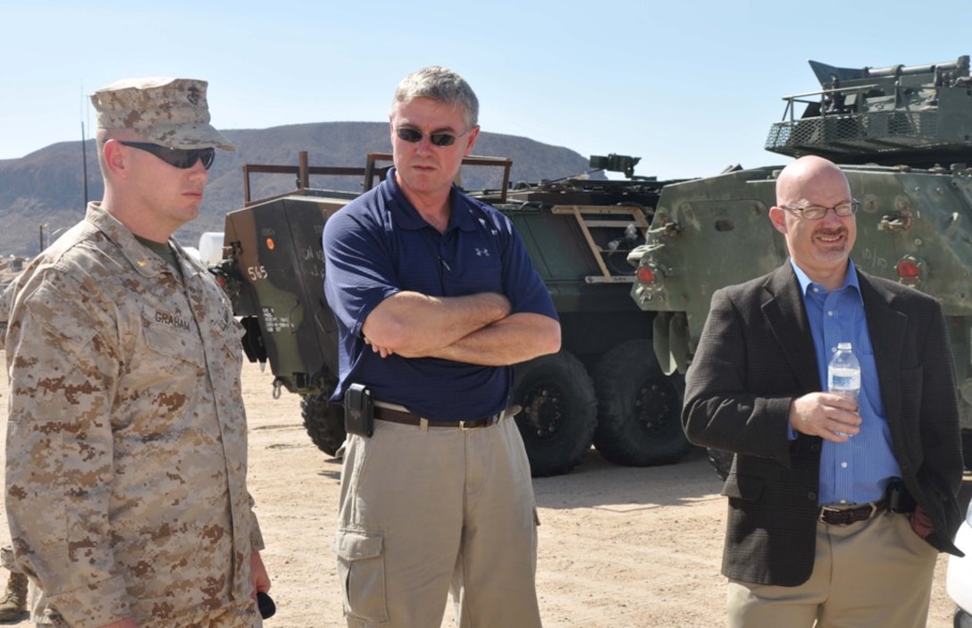 Maj. Michael R. Graham, director of Fleet Support Division, MCLB Barstow, takes students with the Defense Acquisition University to the team track aboard the Yermo Annex, Oct. 10. The team track is the first step in receiving gear, conducting inventory accountability and quality assurance and quality control checks. Graham explains the storage and shipping procedures for the equipment that comes into FSD. Photo by: Gunnery Sgt. Reina Barnett

