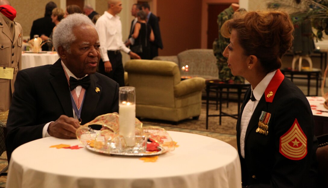 Sgt. Maj. Yolanda Mayo, the sergeant major of Marine Air Control Squadron 24, gets acquainted with Ambassador Ted Britton, an original Montford Point Marine and a Congressional Gold Medal recipient, during a gala for the Museum of the Marine aboard Marine Corps Base Camp Lejeune Oct. 6. Britton was one of the distinguished guests at the fundraiser for the museum. (Official Marine Corps photo by Lance Cpl. Scott W. Whiting) 