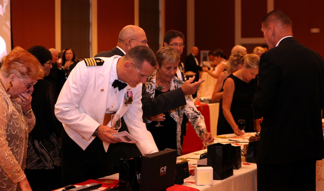 Participants at the gala for the Museum of the Marine scour the tables looking for an item to bid on during the silent auction aboard Marine Corps Base Camp Lejeune Oct. 6. The silent auction featured everything from watches to bathroom sinks, and was used as a fundraiser for the upcoming construction of the museum. (Official Marine Corps photo by Lance Cpl. Scott W. Whiting)