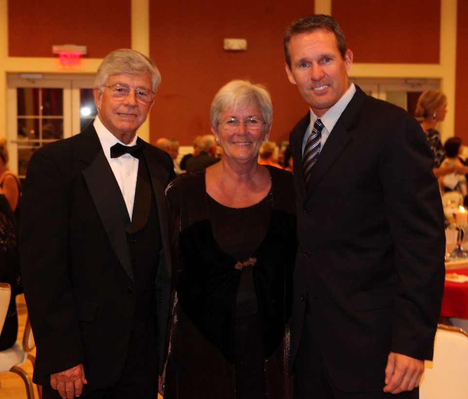 A couple poses for a picture with Olympic gold medalist Dan Jansen during the gala for the Museum of the Marine aboard Marine Corps Base Camp Lejeune Oct. 6. Jansen was the keynote speaker at the event and talked about the importance of overcoming struggles in life. (Official Marine Corps photo by Lance Cpl. Scott W. Whiting)