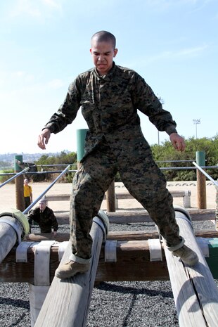 A recruit of Company E, 2nd Recruit Training Battalion, manuevers down a portion of the "O-course" aboard Marine Corps Recruit Depot San Diego, Oct. 4. The "O-course" is a series of elevated bars, logs and walls that allow recruits to quickly move through.