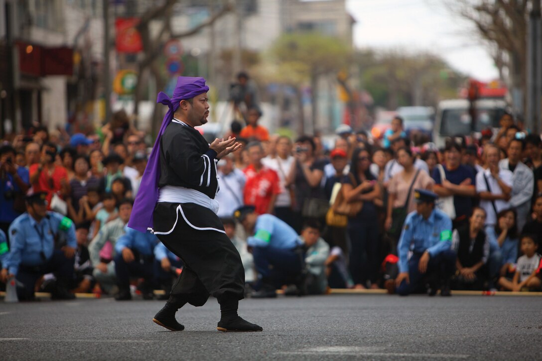 An actor representing the west team performs ritual karate demonstrations before the annual tug-of-war in downtown Naha Oct. 7. Marines and sailors with the single Marine program volunteered at the event. Both the east and west teams performed karate demonstrations before the event began. 