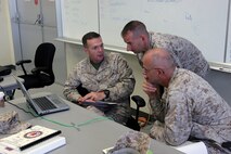 Col. Jay M. Bargeron, left, and Lt. Col. Todd P. Simmons, middle, explain career options to Col. Stephen J. Gabri at Camp Foster Oct. 8. Marines with Manpower Management Officer Assignments met with officers stationed on Okinawa to evaluate and assist them with career progression and development. “Our job is to make sure officers are placed in billets that are right for them,” said Bargeron. “We figure out what the officers want to do, but the needs of the Marine Corps ultimately determine where their career will develop.” Bargeron is a ground colonel monitor, and Simmons is a ground lieutenant colonel monitor with MMOA, Manpower and Reserve Affairs. Gabri is the chief of staff, 3rd Marine Logistics Group, III Marine Expeditionary Force.