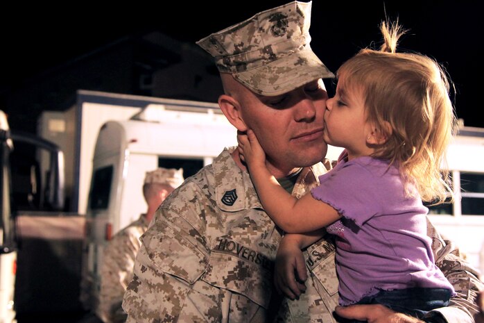 Gunnery Sgt. Jared Hoversten, Regimental Combat Team 7, 7th Marine Regiment, gets a goodbye kiss from his 22-month-old daughter, Kaydence,  Tuesday before he boards a bus and heads to Afghanistan.