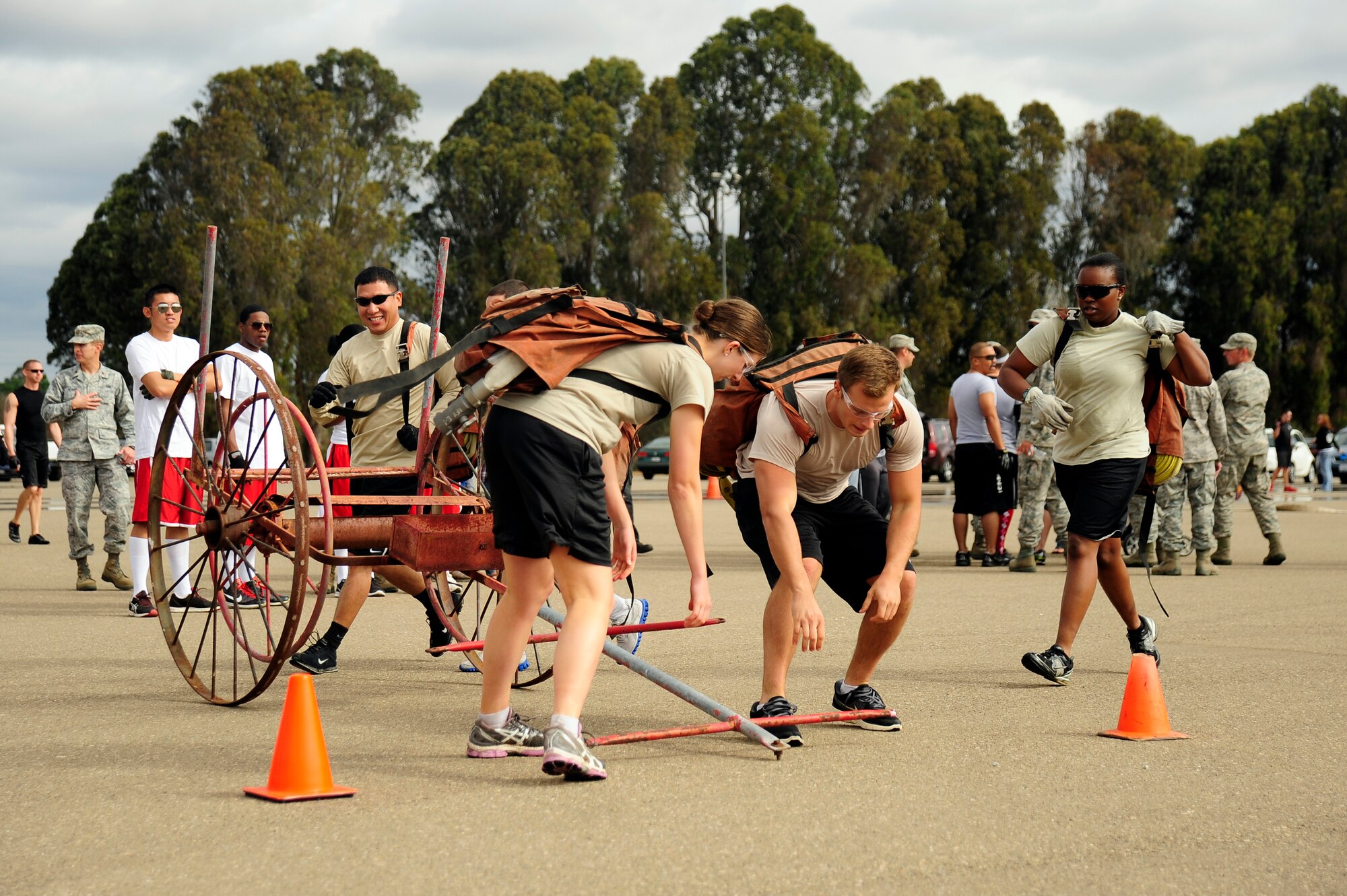 VANDENBERG AIR FORCE BASE, Calif. -- A team from the 30th Civil Engineer Squadron transitions to the final leg of the obstacle course event at the Fire Muster here Friday, Oct. 12, 2012. The Fire Muster competition is held during Vandenberg's annual Fire Prevention week to demonstrate the rigorous training required of firefighters. (U.S. Air Force photo/Michael Peterson)