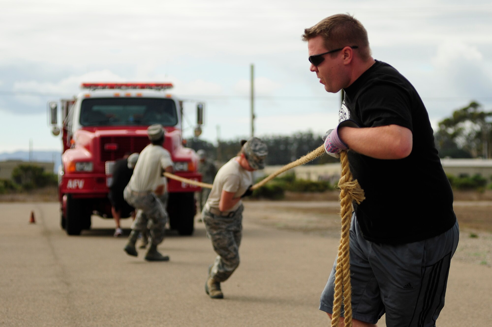 VANDENBERG AIR FORCE BASE, Calif. -- Team Vandenberg personnel compete in the fire truck pull event during the Fire Muster here Friday, Oct. 12, 2012. The Fire Muster competition is held during Vandenberg's annual Fire Prevention week to demonstrate the rigorous training required of firefighters. (U.S. Air Force photo/Michael Peterson)