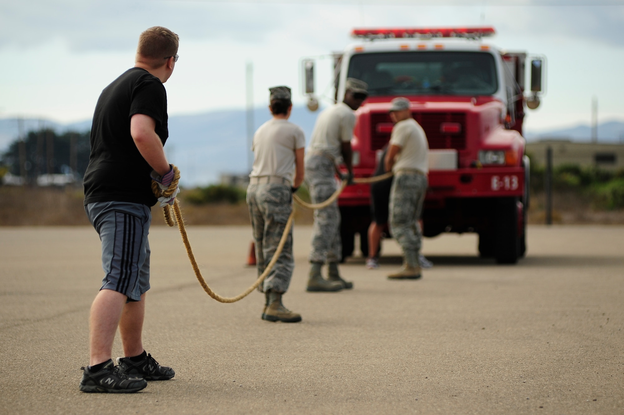 VANDENBERG AIR FORCE BASE, Calif. -- Team Vandenberg personnel prepare for the fire truck pull event during the Fire Muster here Friday, Oct. 12, 2012. The Fire Muster competition is held during Vandenberg's annual Fire Prevention week to demonstrate the rigorous training required of firefighters. (U.S. Air Force photo/Michael Peterson)